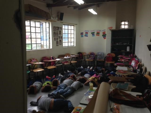 students and teachers practice drills during a gunfire simulation at their school in medellin.