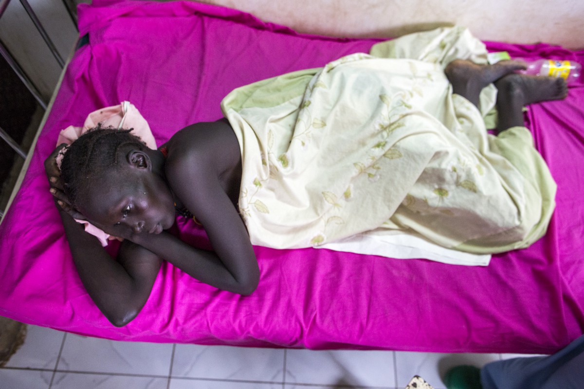 Nyaduel Gony rests after surgery. She lost her unborn baby after suffering a gunshot wound to the abdomen during an attack on her village.