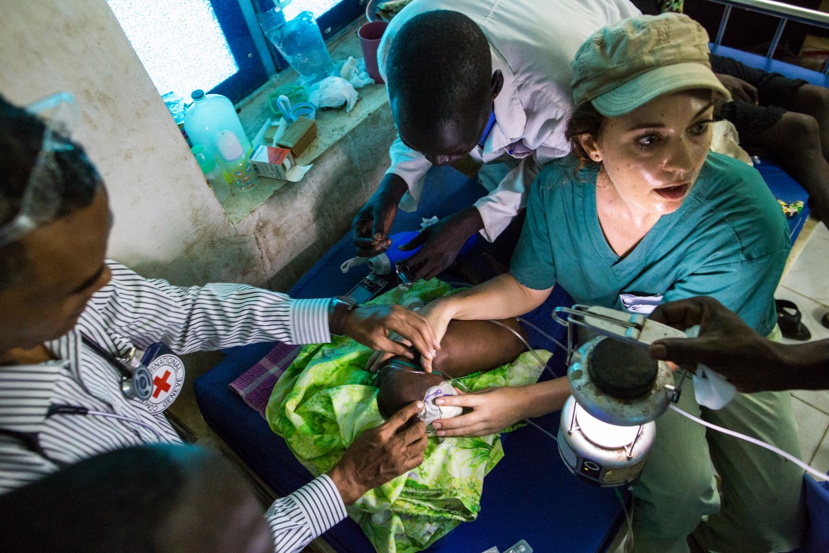 Jessica Hazelwood, right, and her team attend to 5-month-old Nyanene at the Intensive Care Unit of the hospital. Life-saving medical equipment is often not available or reliable.