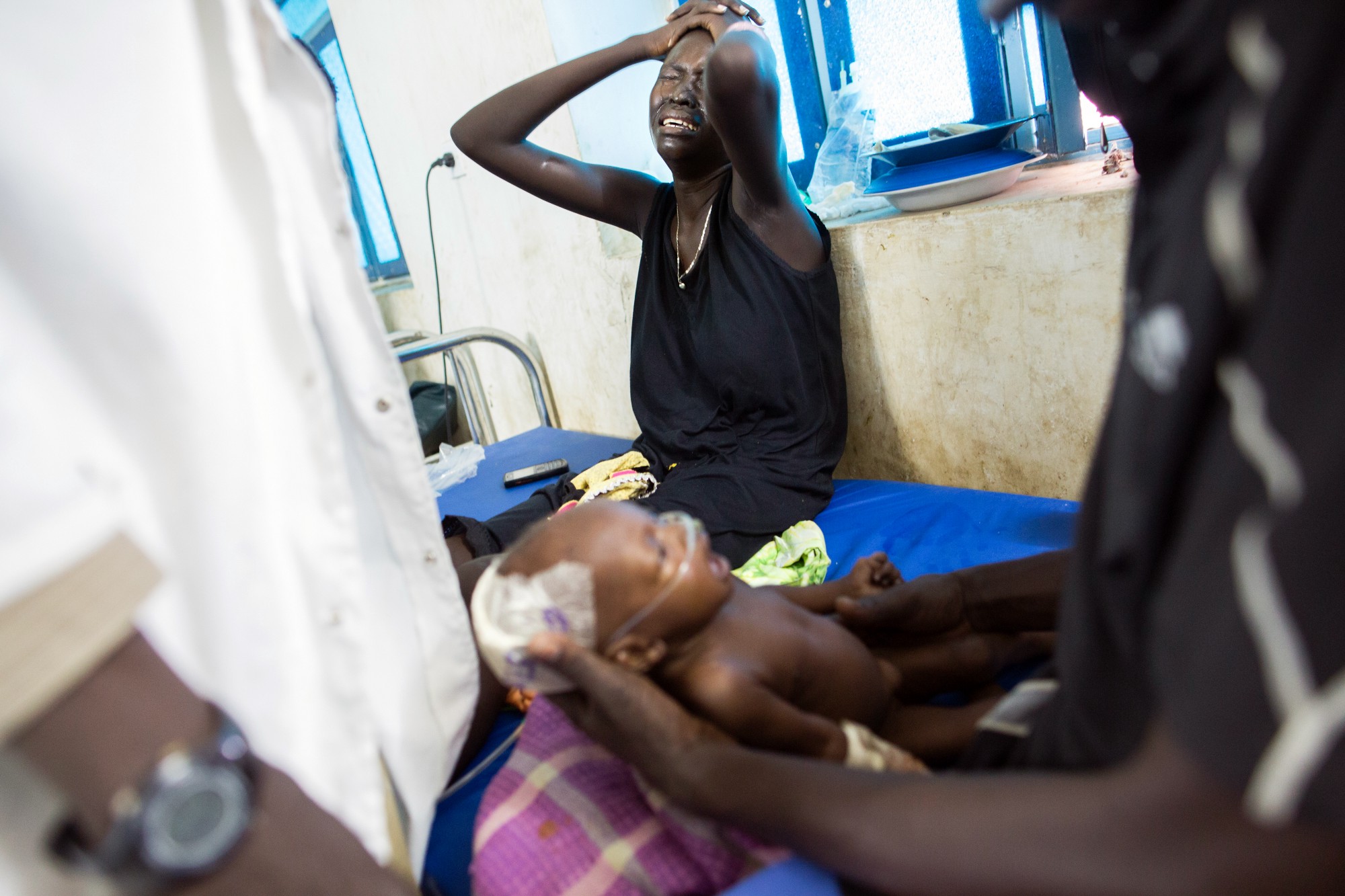 Nyamuoch weeps as she witnesses her daughter’s struggle to hang on. She later passed away due to respiratory failure.