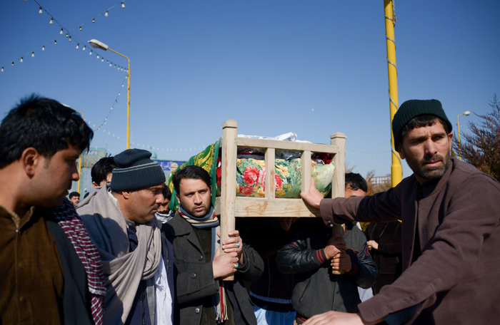 Mourners carry the coffin of one of six Afghan employees of the Red Cross killed in an attack this week in a remote northern province.Farshad Usyan/AFP/Getty Images