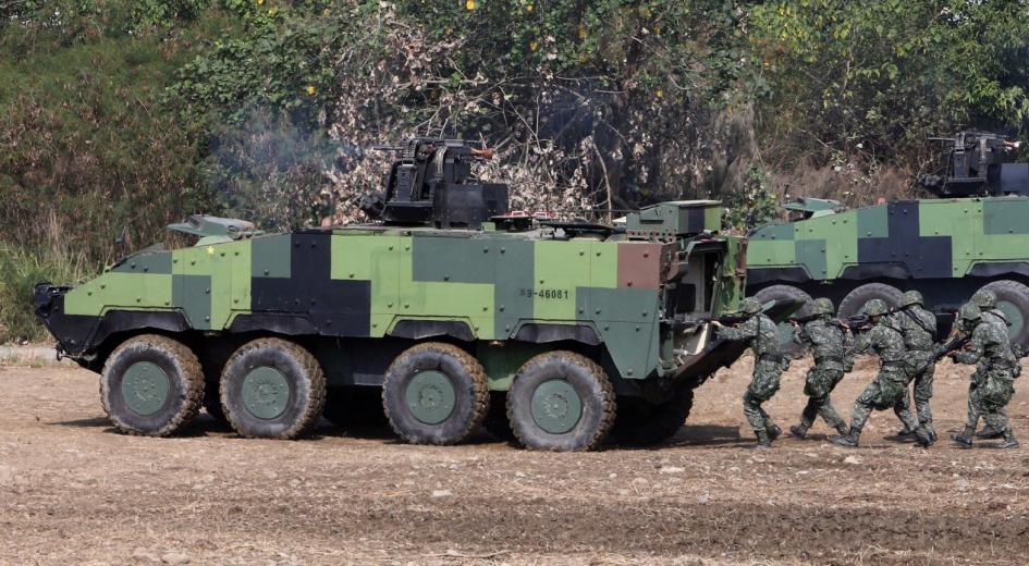 Taiwanese special forces personnel walk behind an armored personnel carrier during an annual military drill in Taichung, Taiwan, January 17, 2017.HANDOUT/REUTERS/Newscom