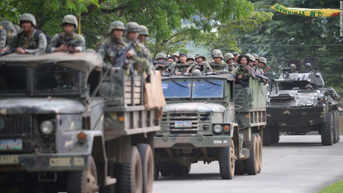 Philippine marines aboard their vehicles maneuver through a street on their way to an assault on the hide out of Muslim militants near the town center in Marawi, in southern island of Mindanao on May 28, 2017.