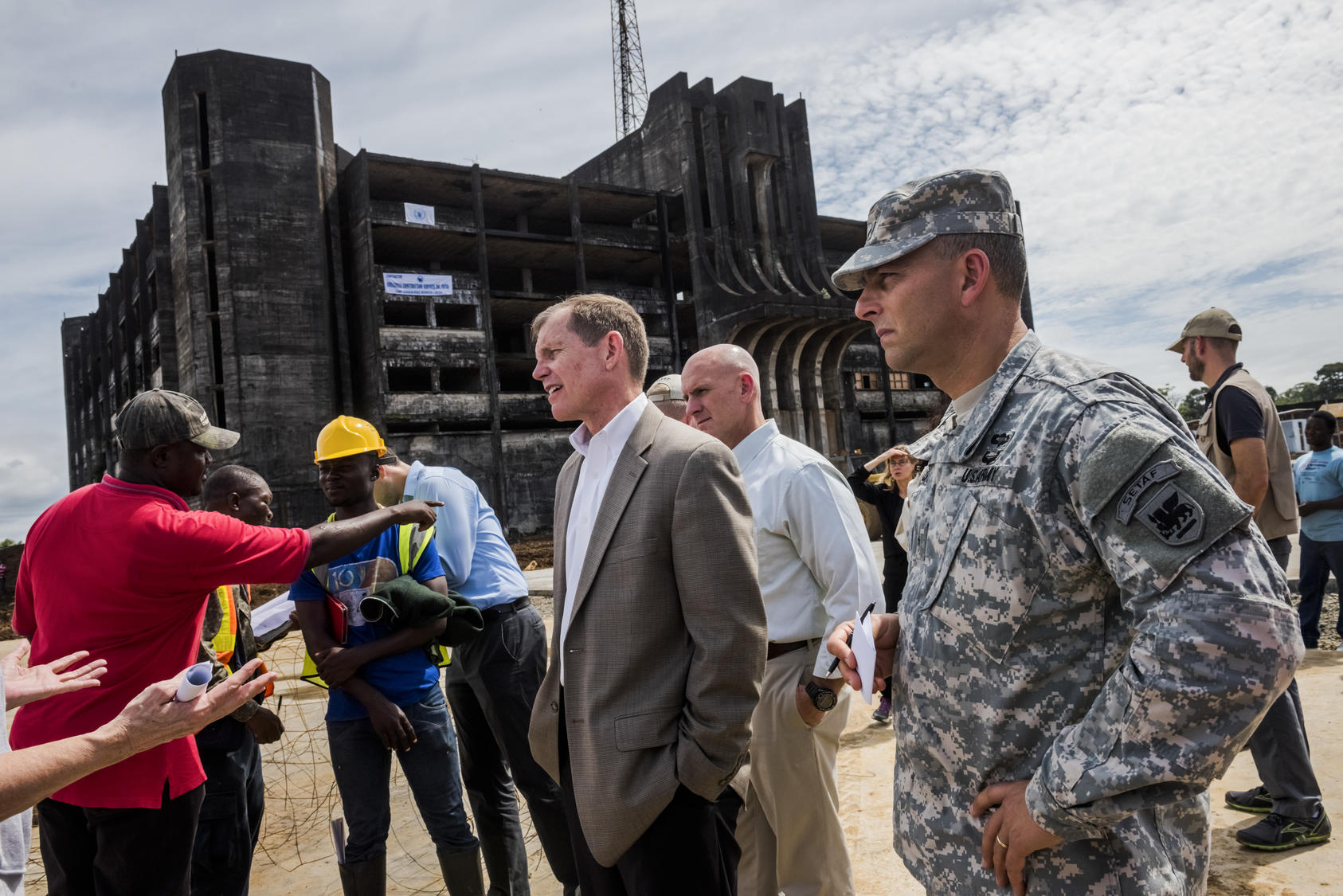 The former U.S. assistant secretary of defense for special operations and low-intensity conflict, and a U.S. delegation tour a construction site of an Ebola treatment center in Liberia, Oct. 2014. Photo Courtesy of The New York Times/Daniel Berehulak