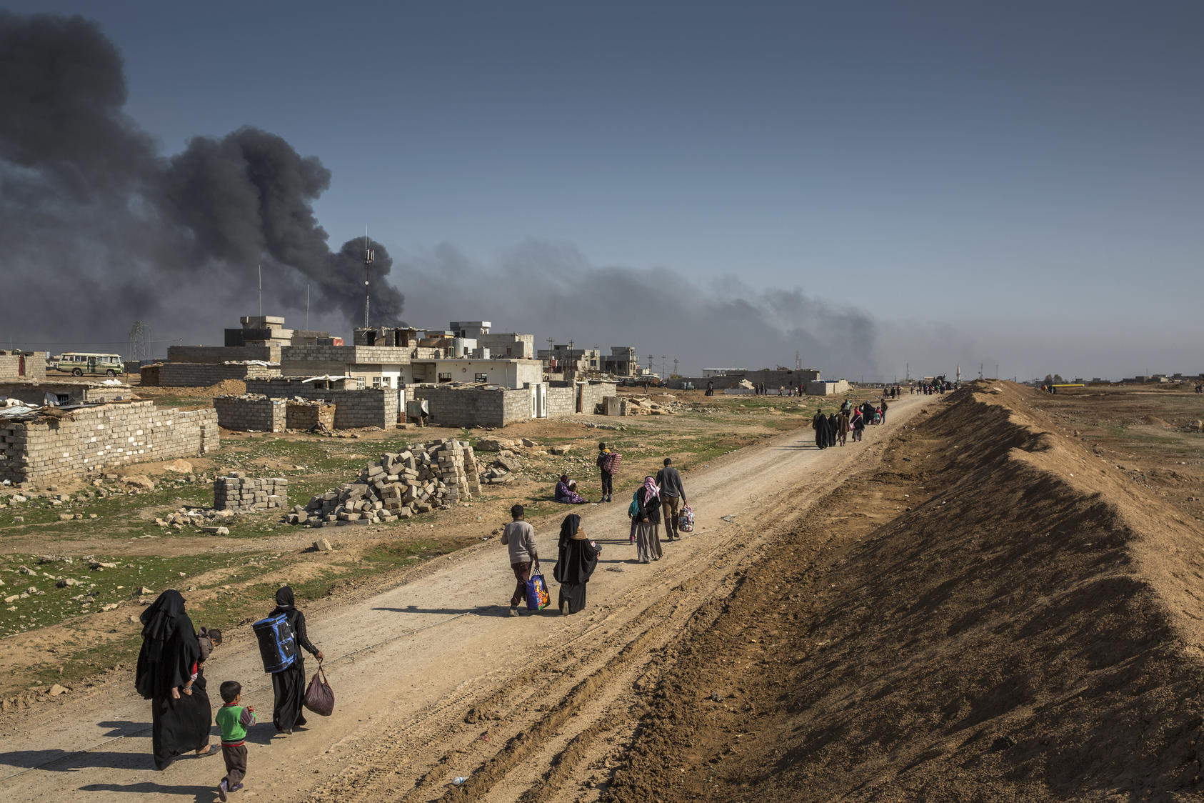 People flee the fighting between Iraqi security forces and Islamic State militants in Mosul, Iraq. Photo courtesy of Ivor Prickett/The New York Times.