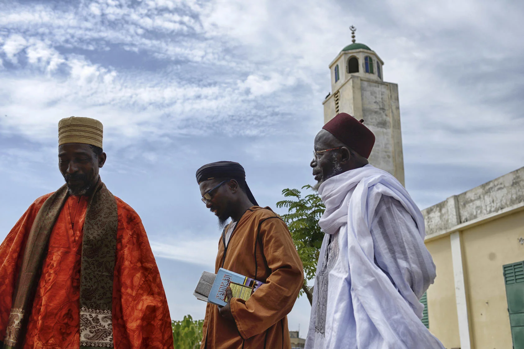 Clergy leave a mosque in Guediawaye, a small village in Senegal where two women were recently arrested for alleged ties to extremists. Photo courtesy of Samuel Aranda/The New York Times.