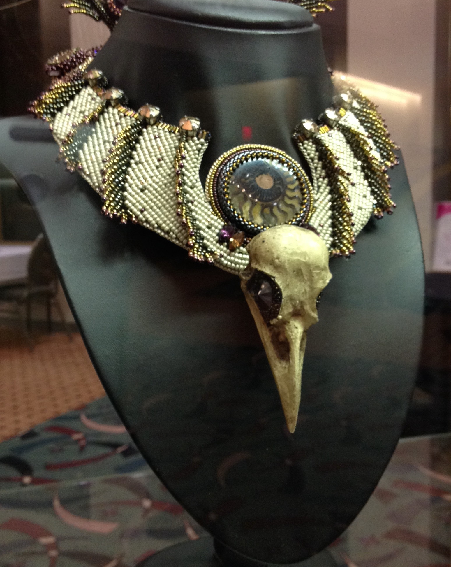 This is just a portion of the finished piece. It had very long feathers coming off the back of the necklace which extended up and over the top of the wearer's head by perhaps a foot or so. I think this was the year of the skulls.