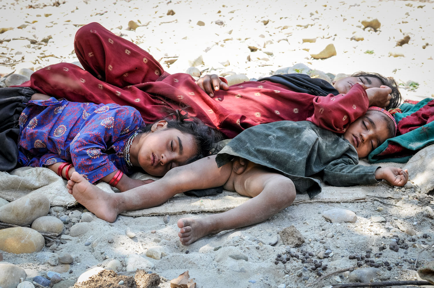 Bashi, Salma, and Yasin, crashed out in the streambed.