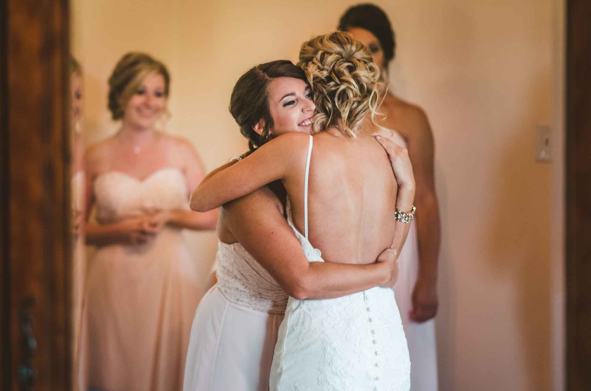 Bride hugging sister before wedding