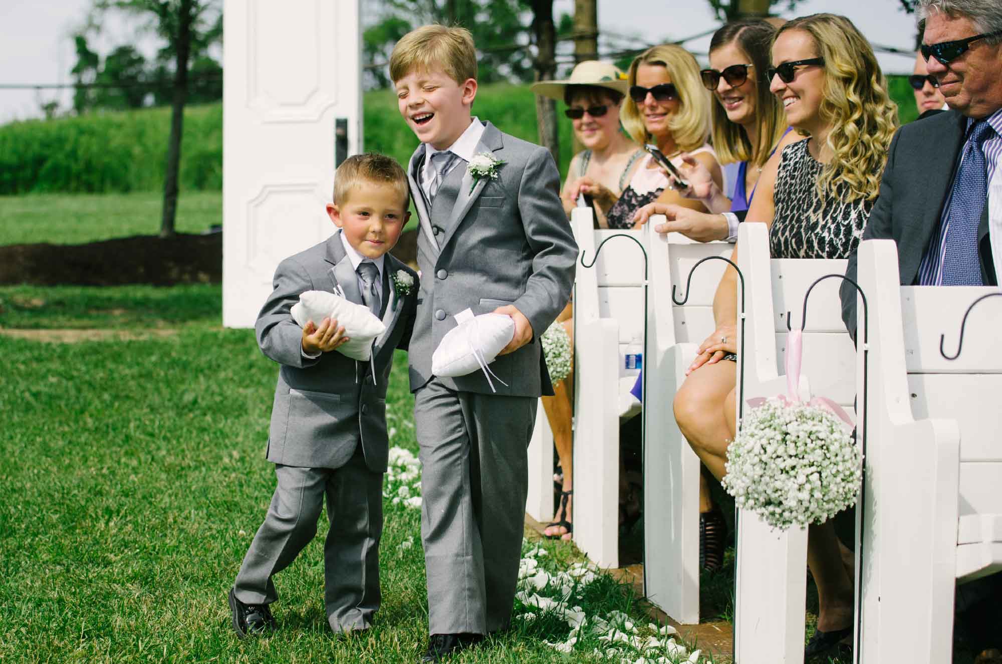 Ring bearers walking down aisle at wedding ceremony