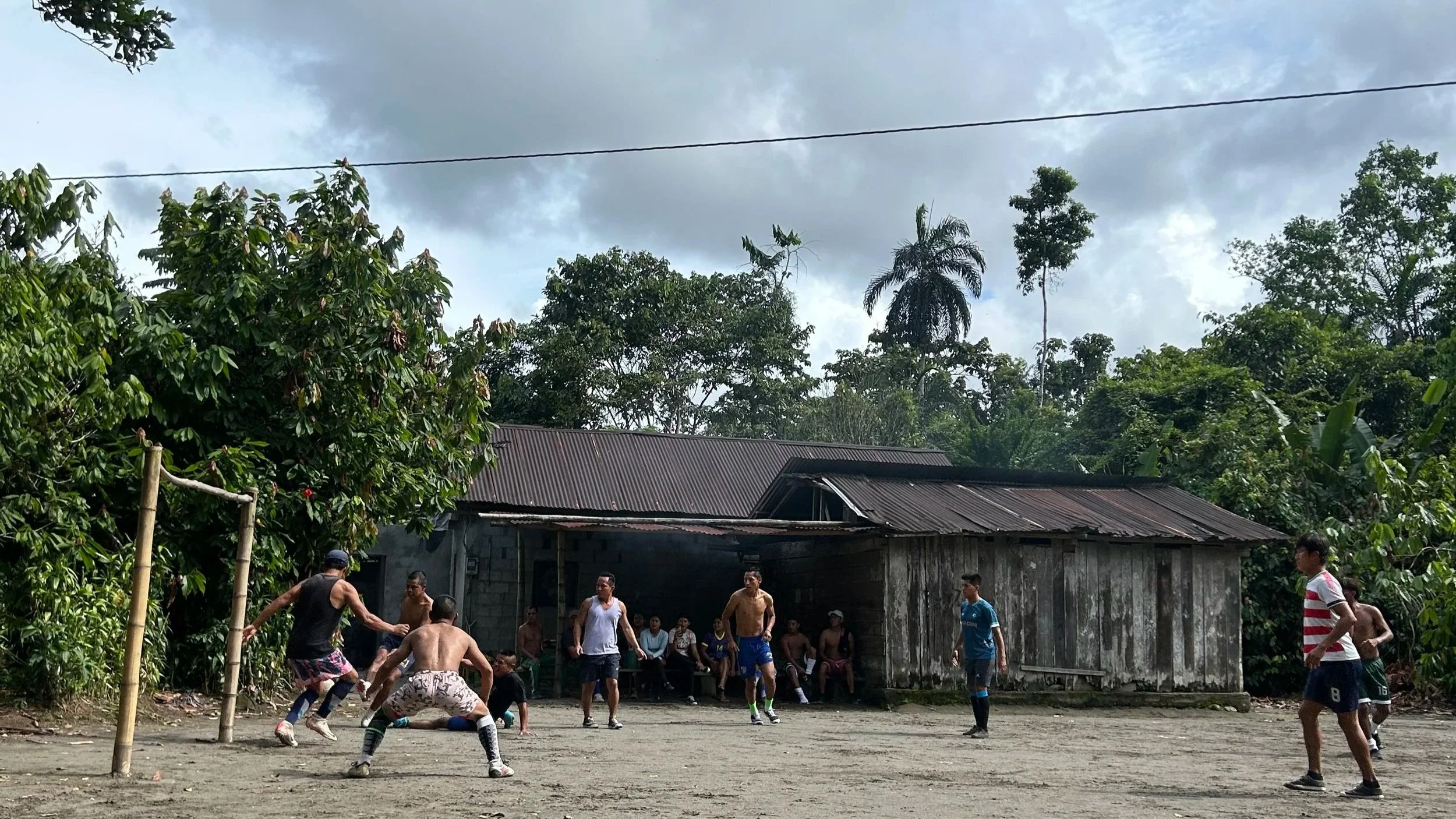 Gap year intern playing soccer with community members in Shandia, Ecuador