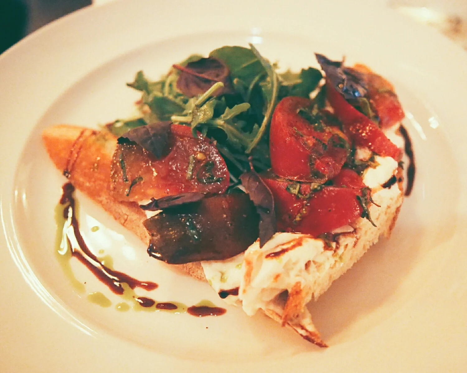 burrata caprese with heirloom tomato, basil, mint, aged balsamic, arugula, extra virgin olive oil on baguette.