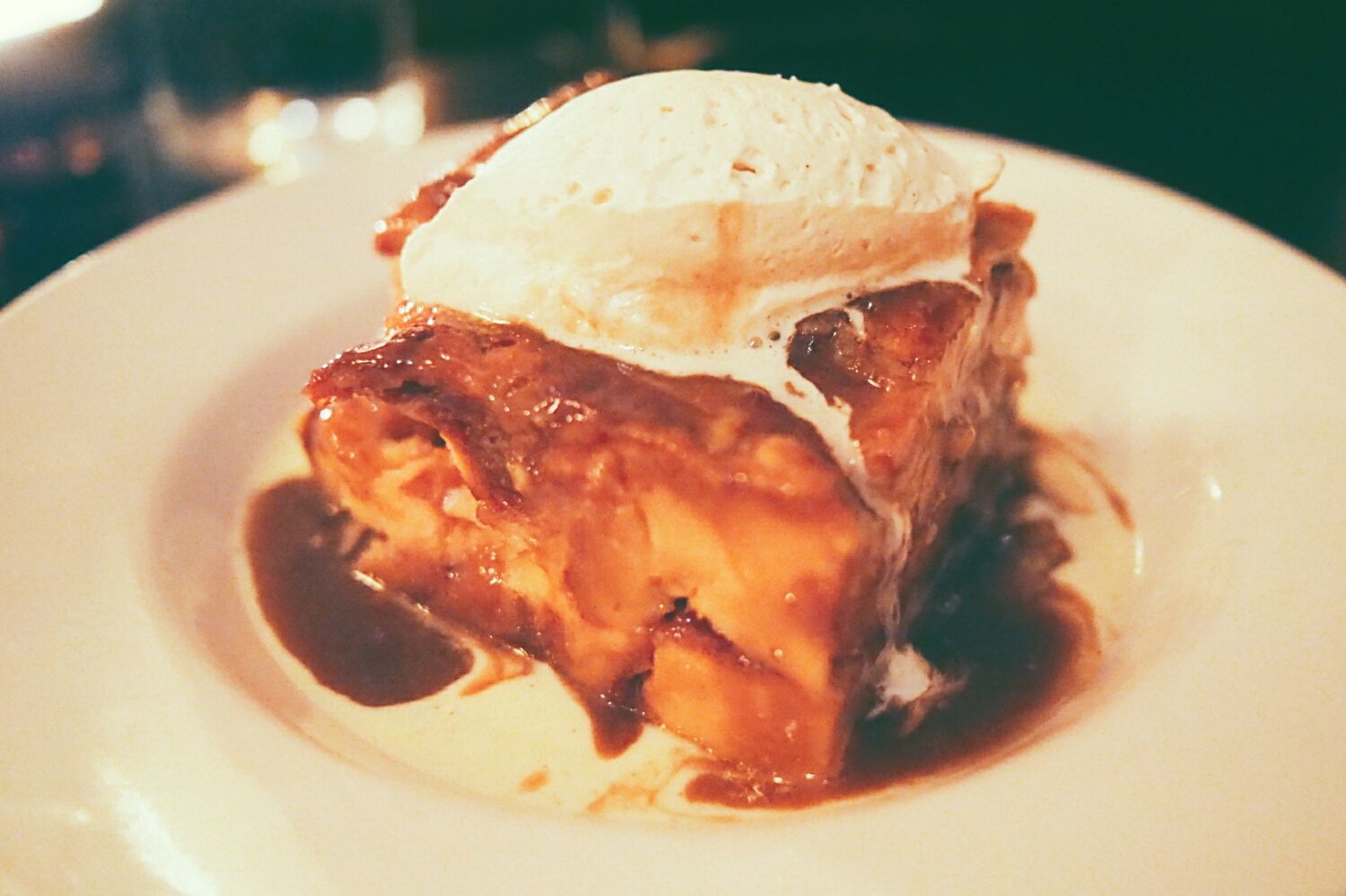 brioche bread pudding with creme anglaise, cinnamon caramel and whipped cream.