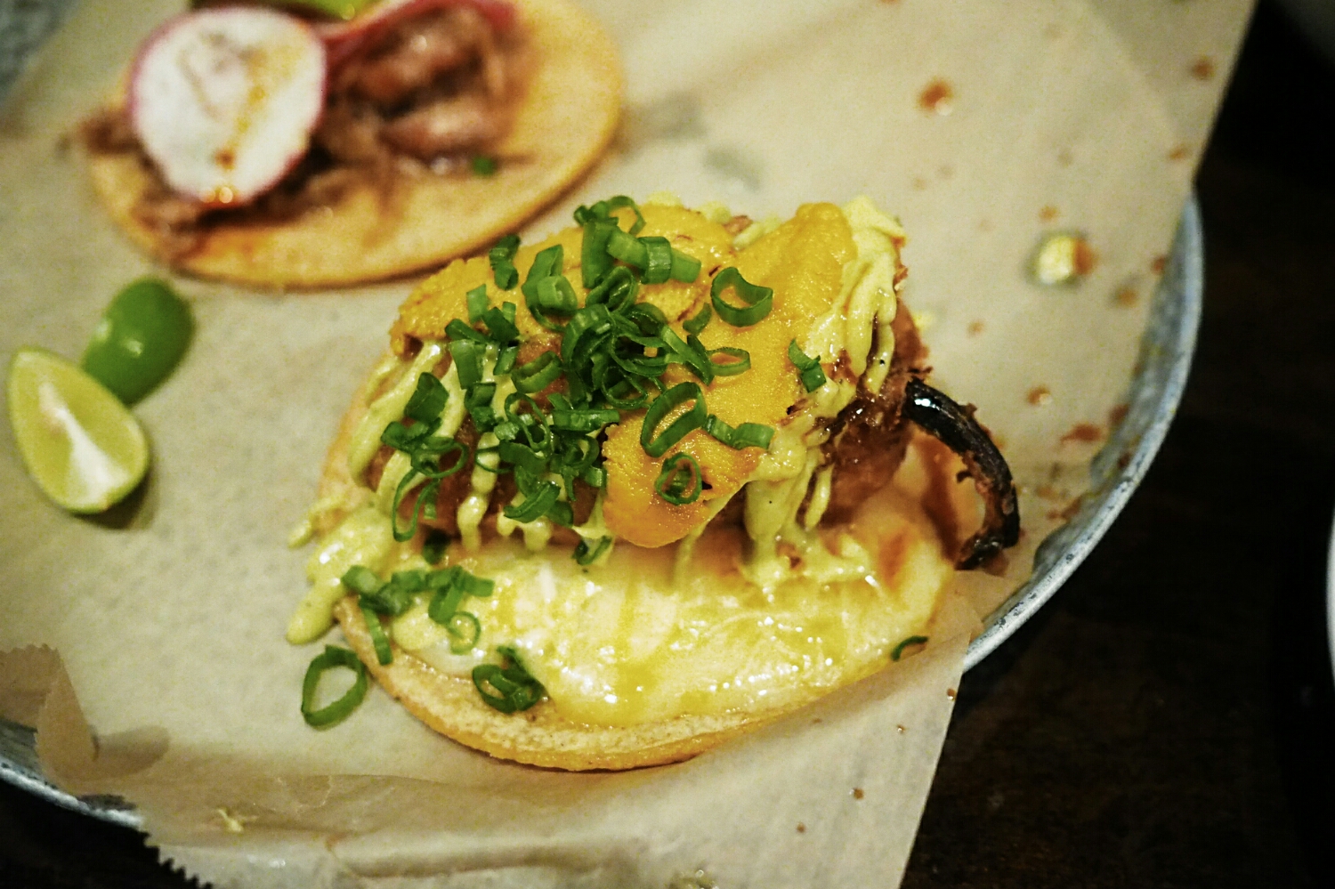 taco sea urchin chile guero: tempura battered and fried chile guero filled with shrimp and green onion on a bed of tres quesos, topped with serrano soy salsa, wasabi aioli and fresh sea urchin.