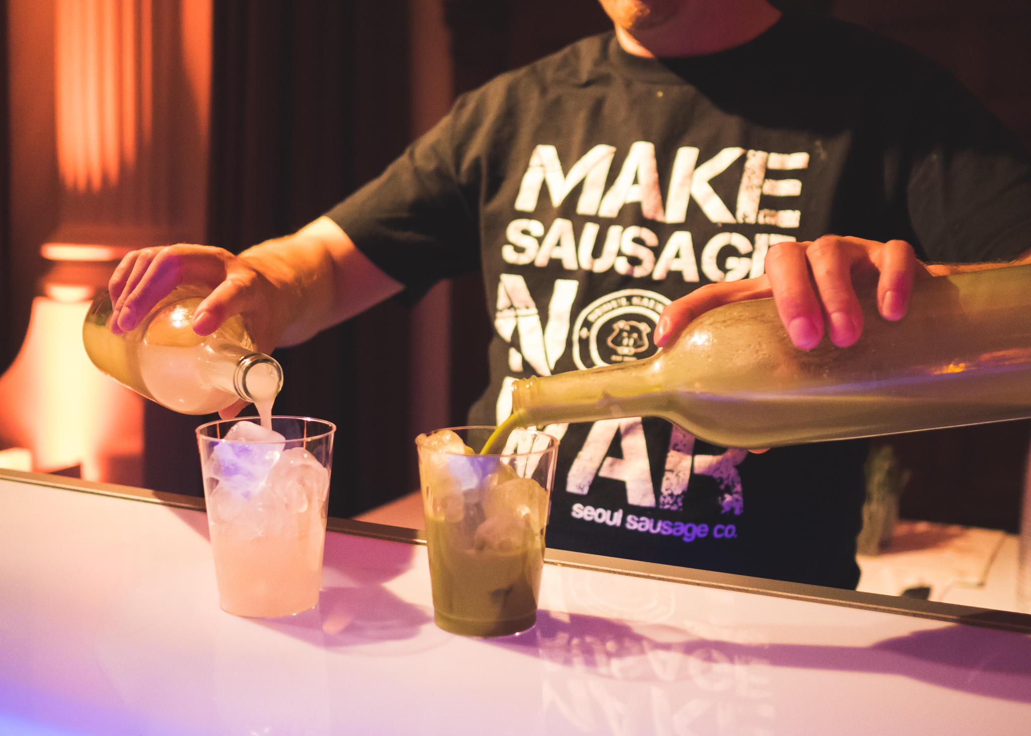 seoul sausage co pouring their two drink options.