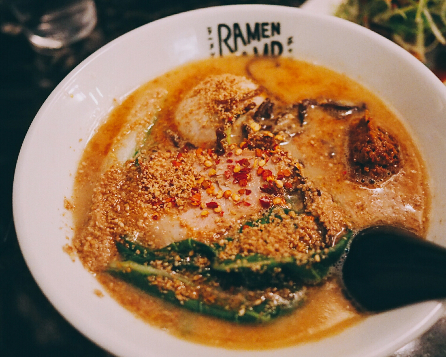 tonkotsu tan tan with tonkotsu broth, seasoned egg, komatsuna green, roasted white sesame, chili and hotmeat sauce seasoned with sichuan peppercorns and garlic.