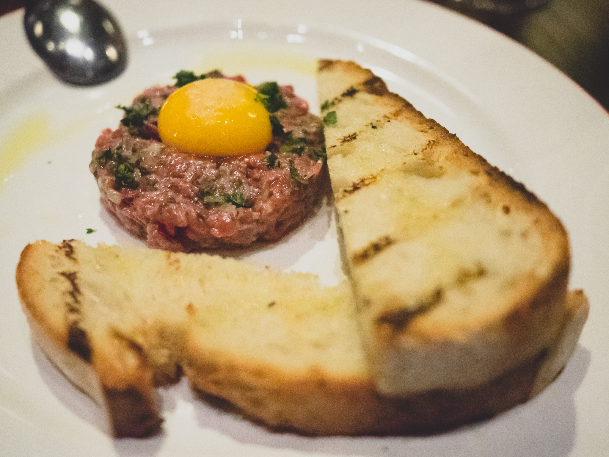 beef tartare with cornichons, shallot and belcampo yolk.