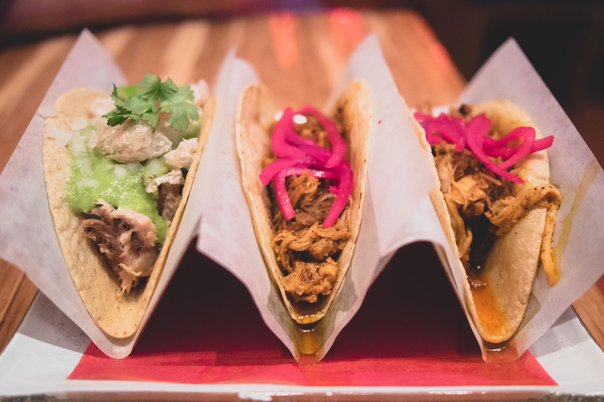 tacos carnitas (braised baby pig with pork rinds, spicy salsa verde cruda) and cochinita (yucatan style pit barbecue pork with marinated onions).