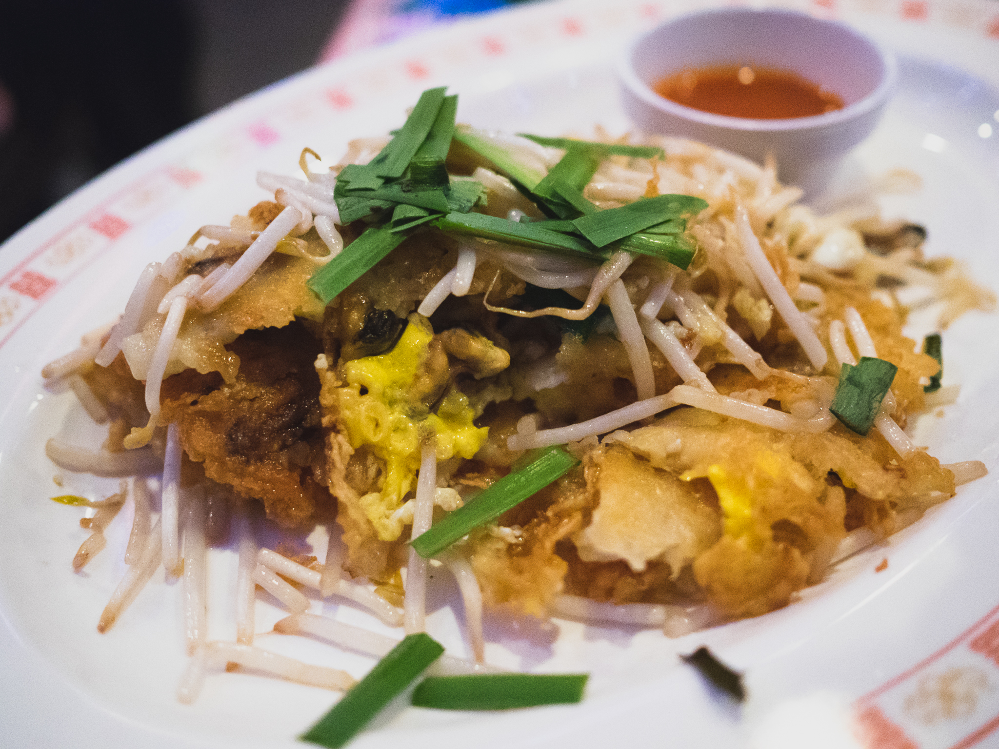 hoi thawt : crispy broken crepe with steamed fresh mussels, eggs, garlic chives, bean sprouts, thai sri racha.
