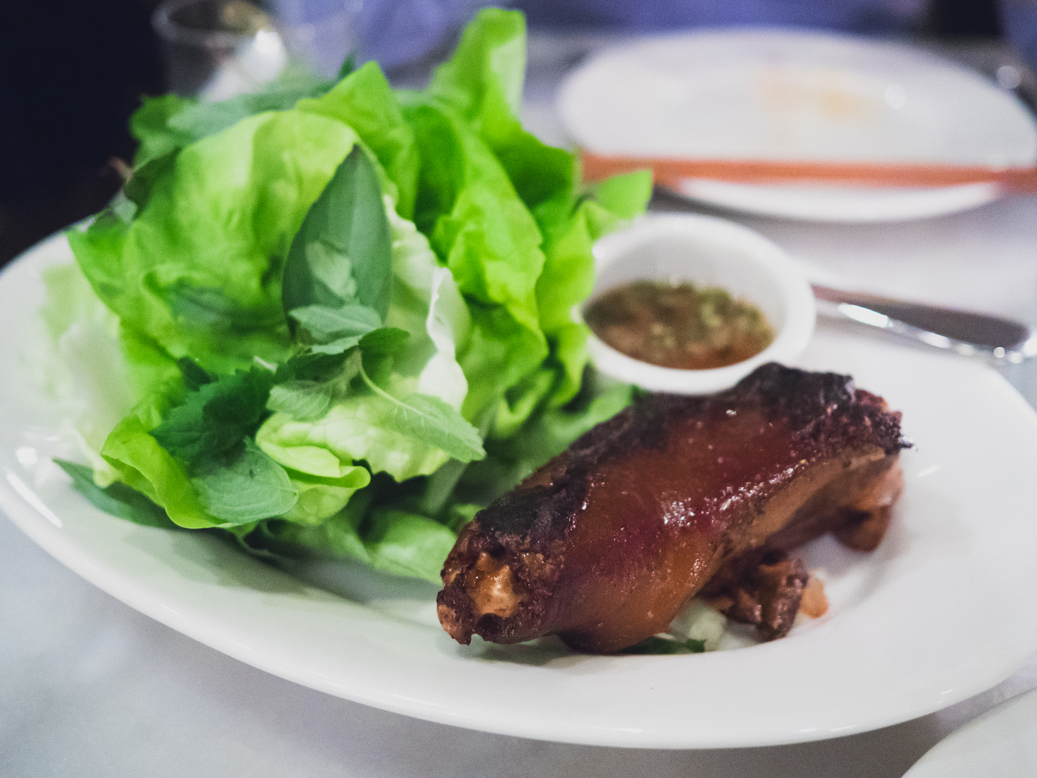 grilled pig's tail with bibb lettuce, herbs and fish sauce.