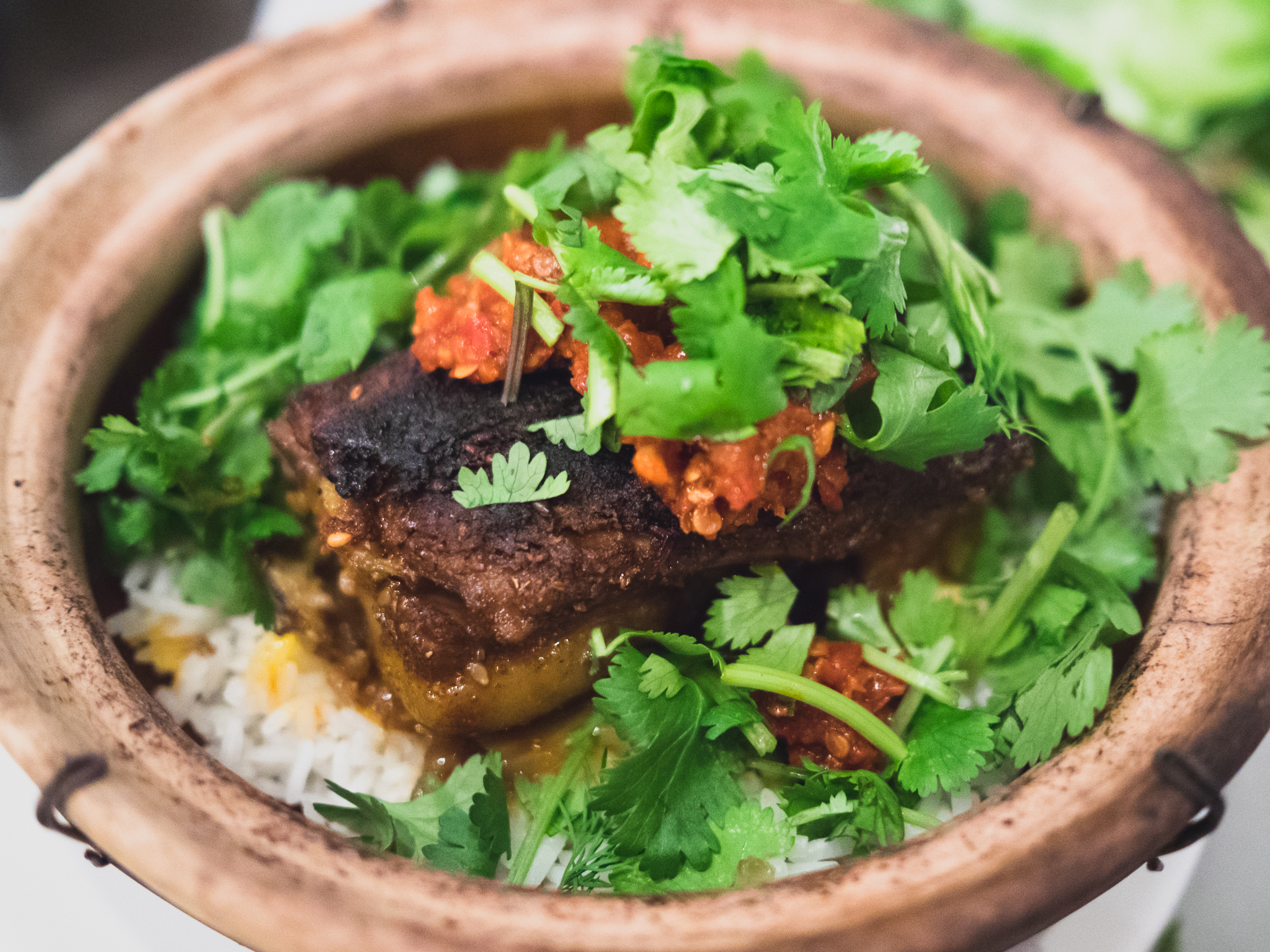 grilled spicy lamb breast with sichuan peppercorn, cumin, sambal, jasmine rice and sesame sauce.
