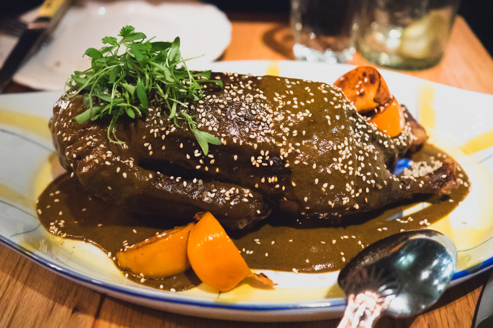 half duck with sesame, mole, persimmon.
