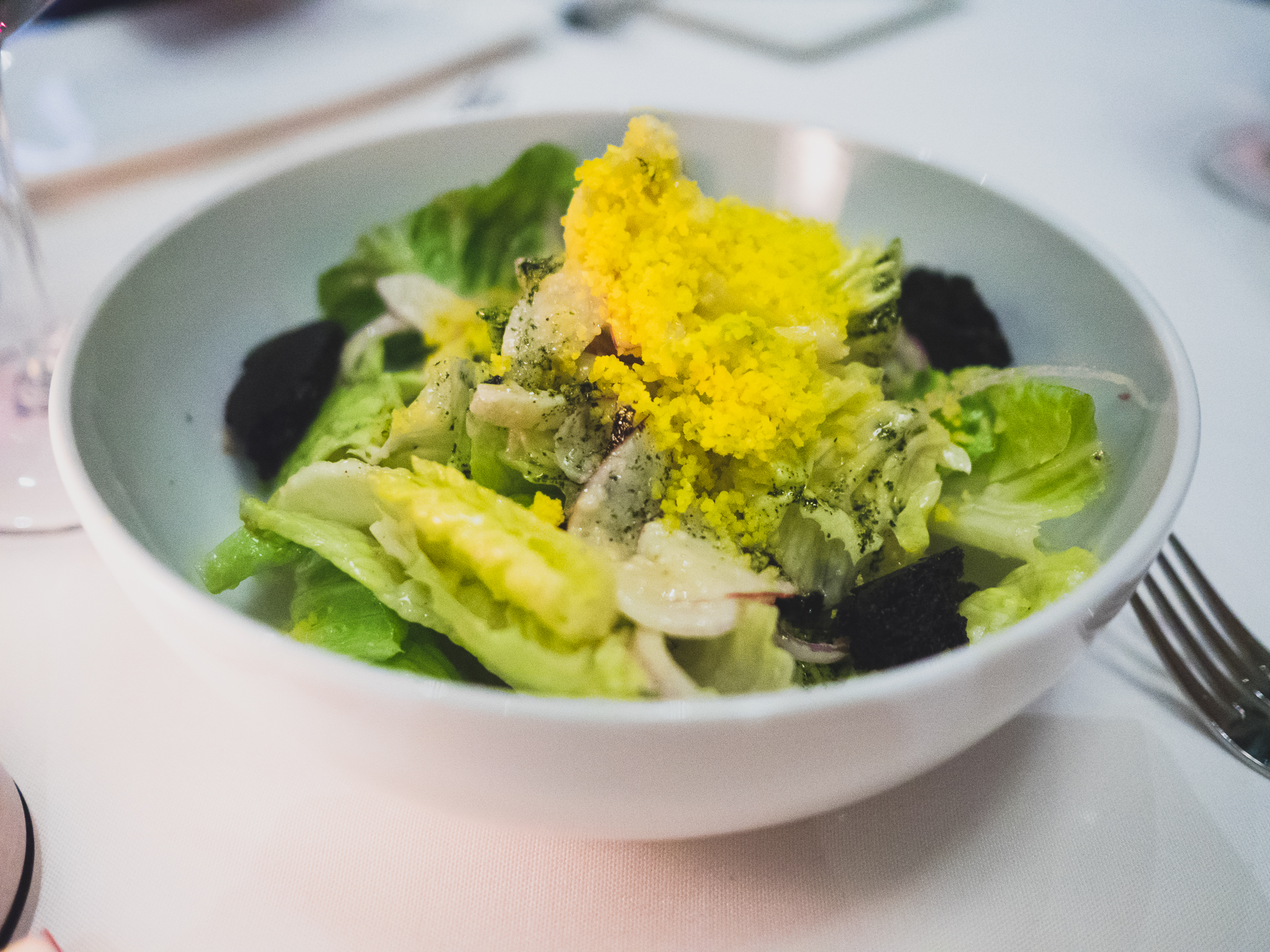 little gem and romaine salad with anchovy miso dressing, furikake, fennel and squid ink croutons.