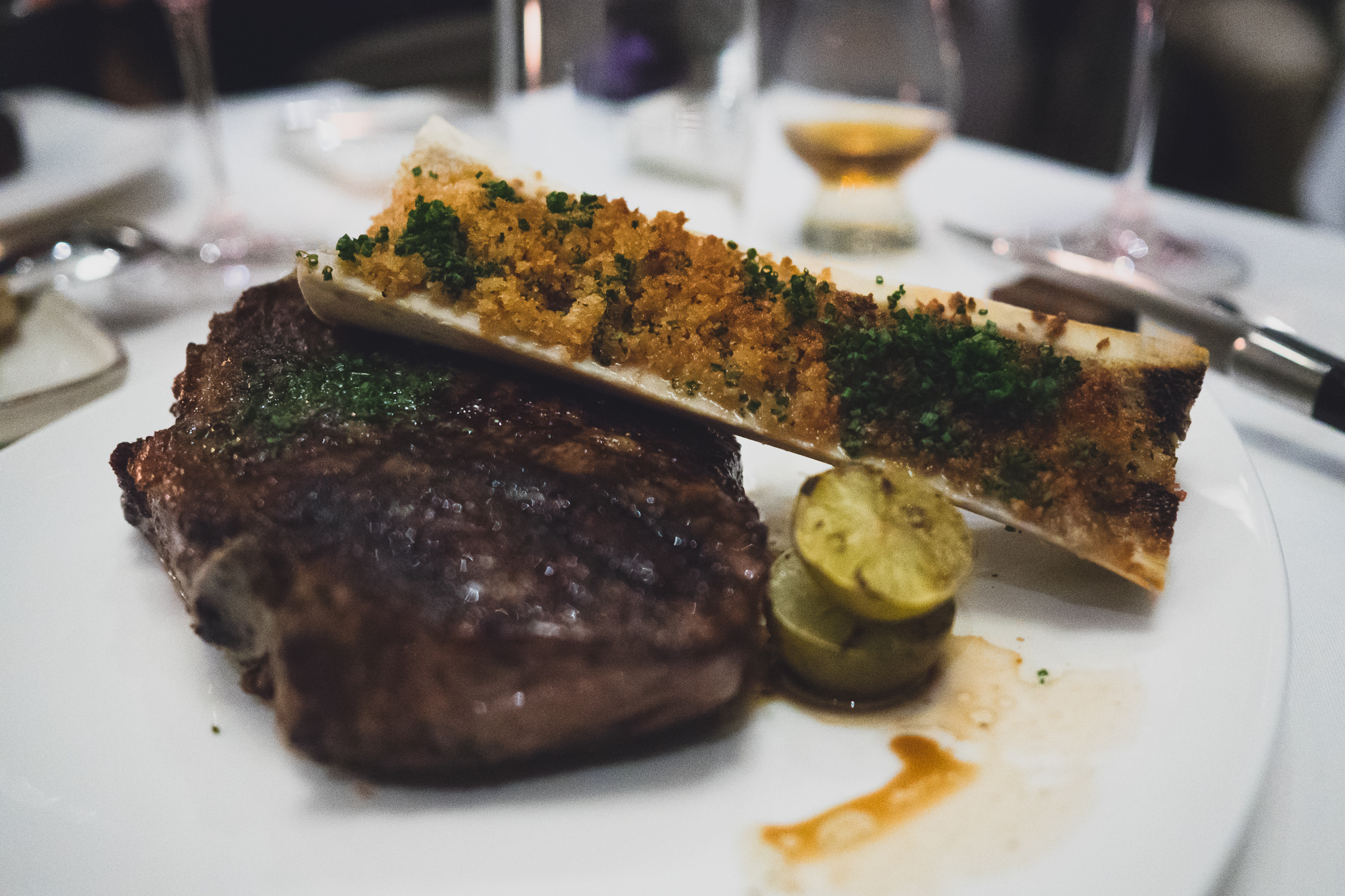 bone in new york with grilled sudachi, chive butter and bone marrow enhancement.