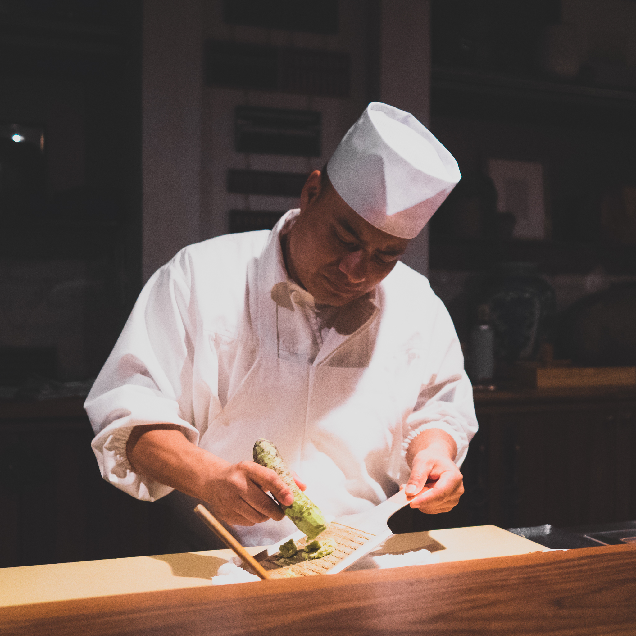 grating fresh wasabi between the tsumami and nigiri sushi courses.