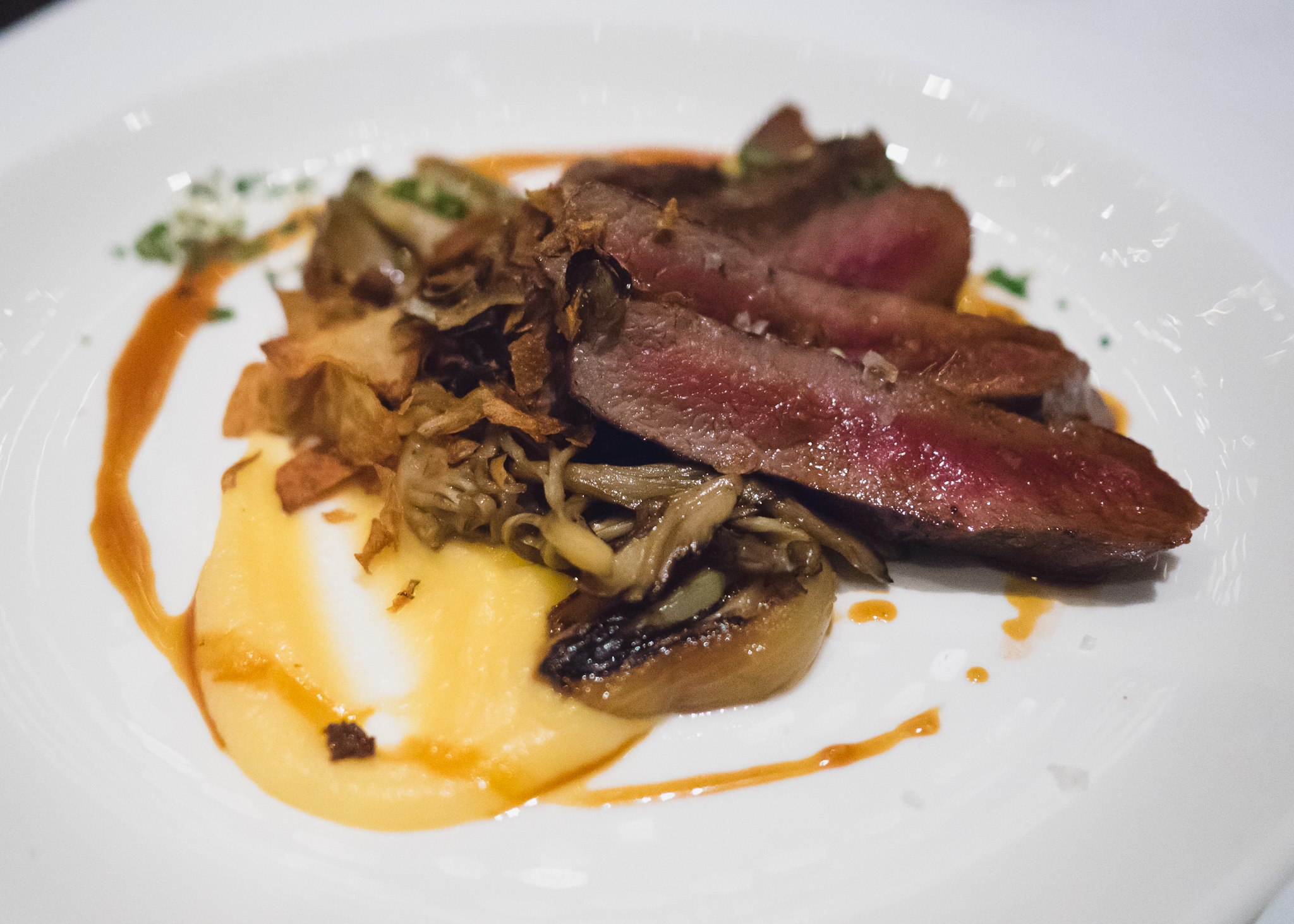 elk loin with charred onions, red wine salsify, maitake mushrooms, gremolata.
