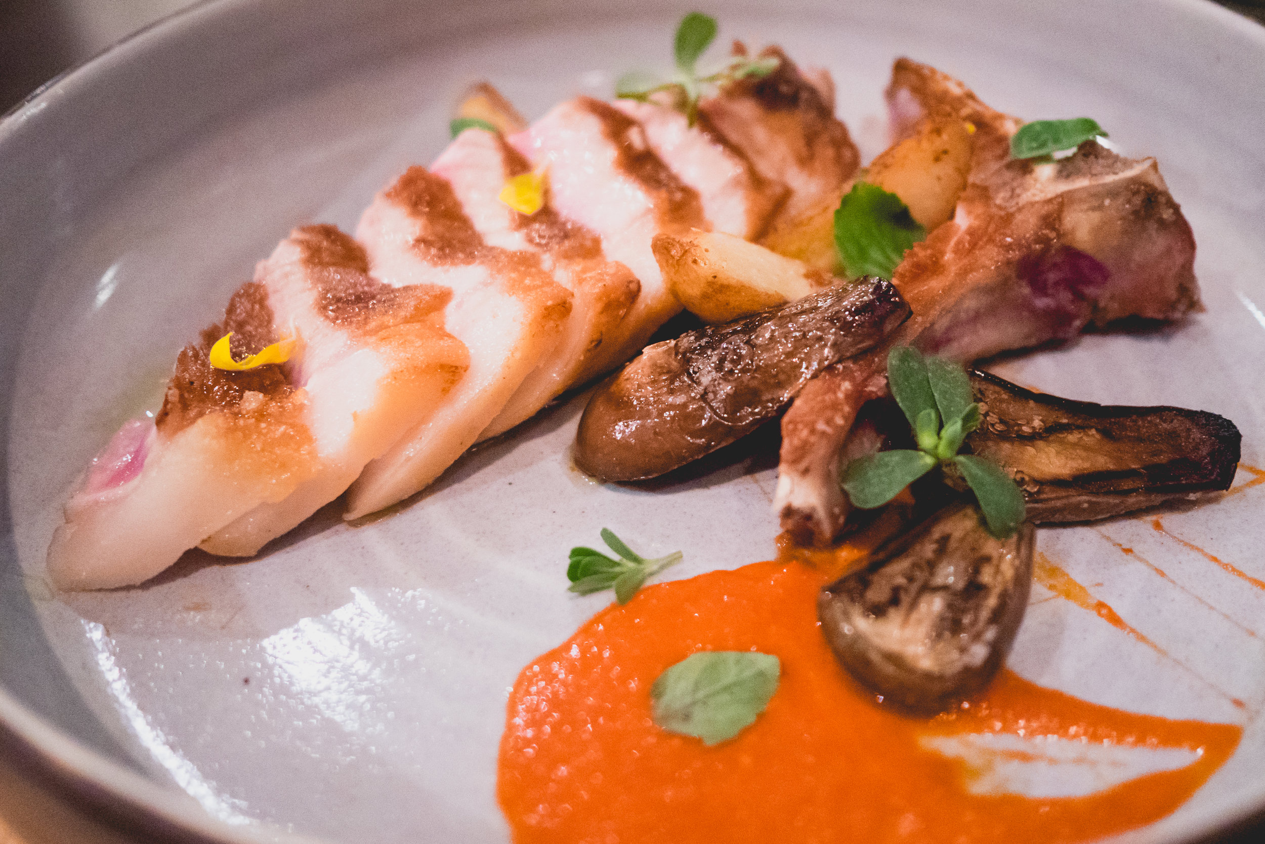 dry aged pork chop , confit baby eggplant, home fries, chili sauce.
