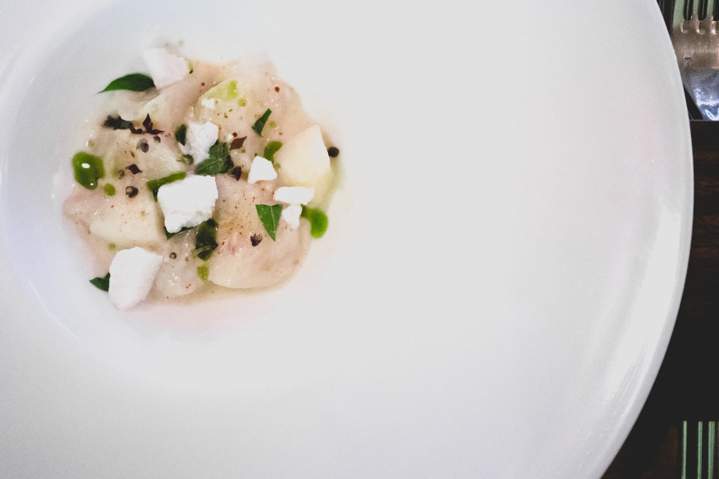 i. diver scallop crudo, melon, horchata rice, coconut ice, basil flower, leaf and oil.