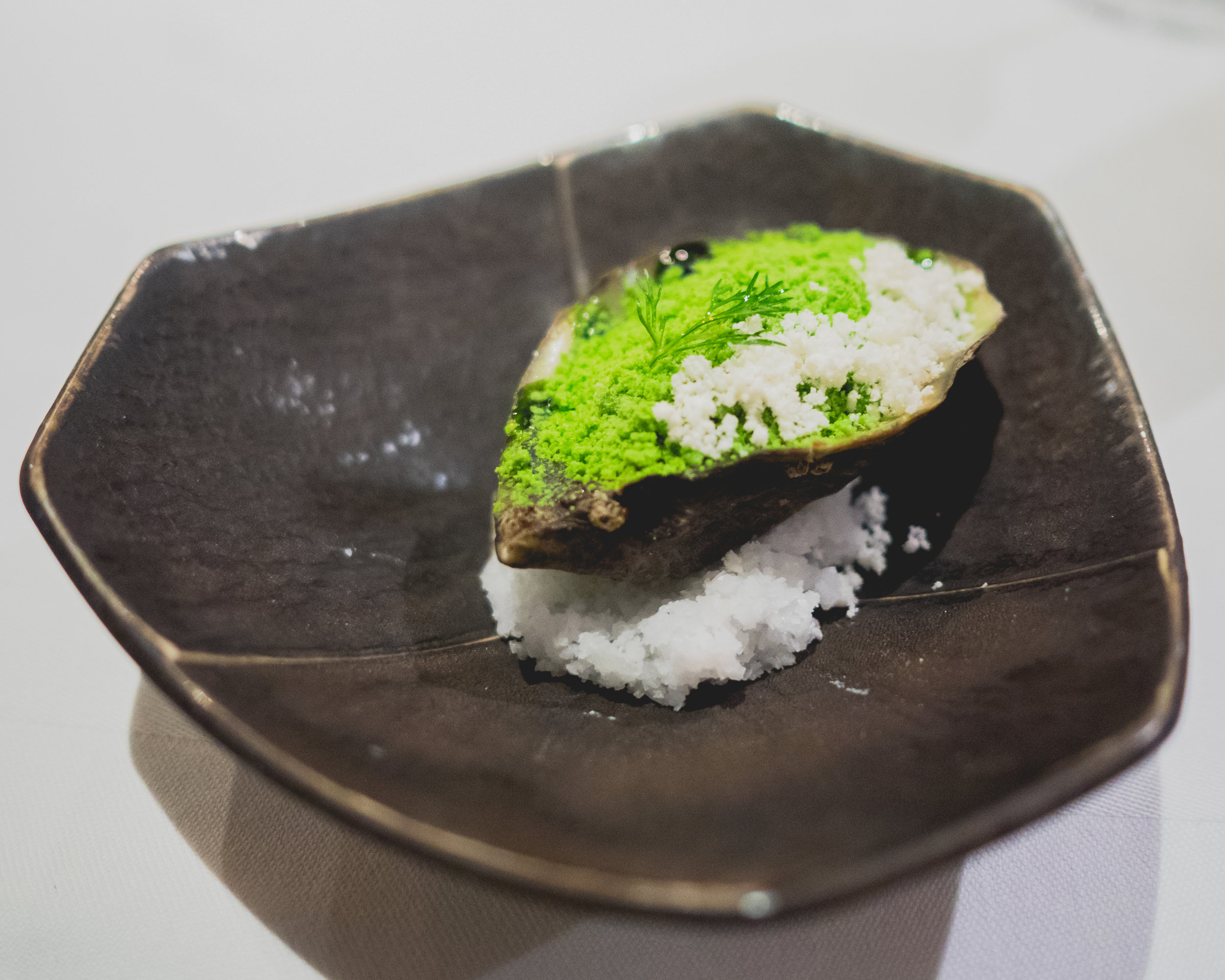 amuse: cold-smoked shigoku oyster, horseradish powder, dill powder, dill oil.