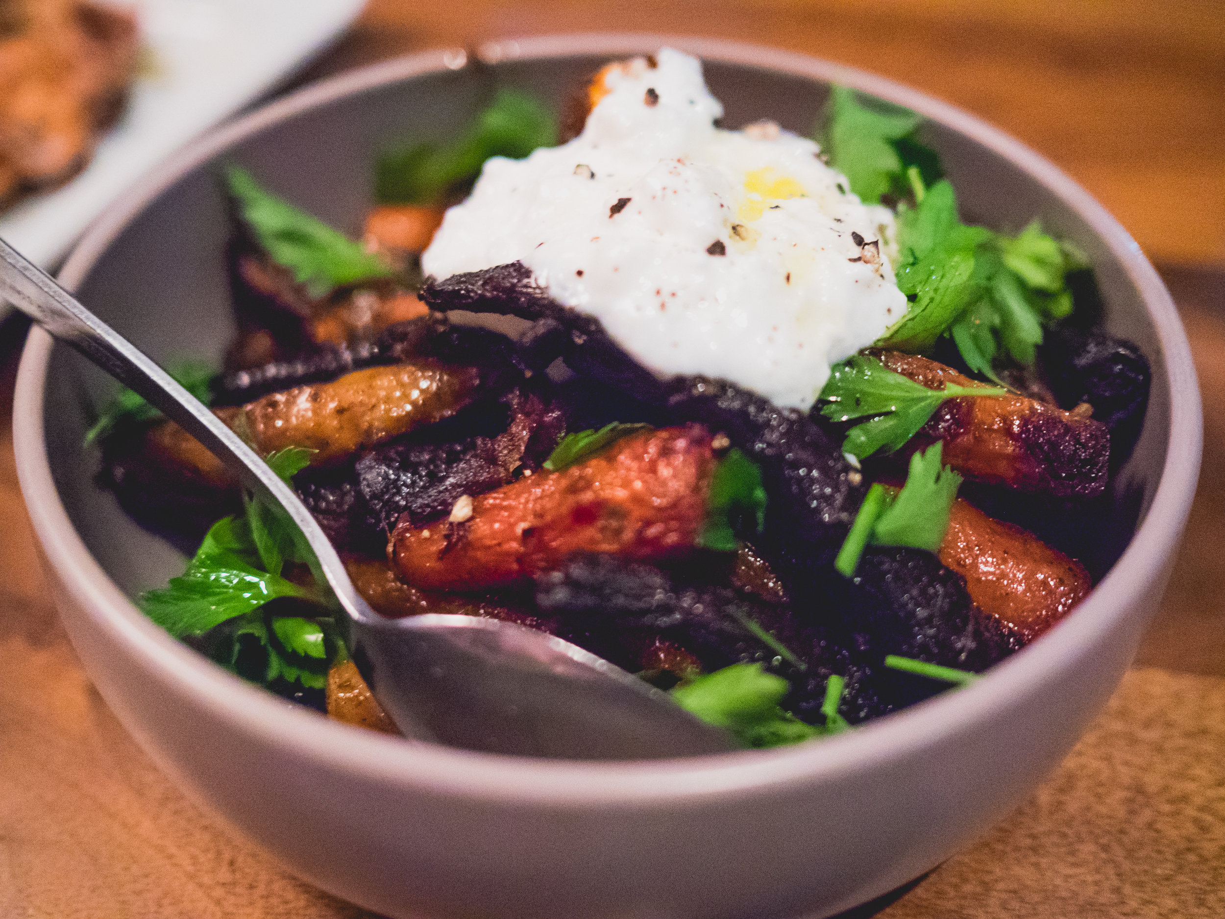 coal roasted carrots , sheep's milk ricotta, herbs, honey and black pepper.