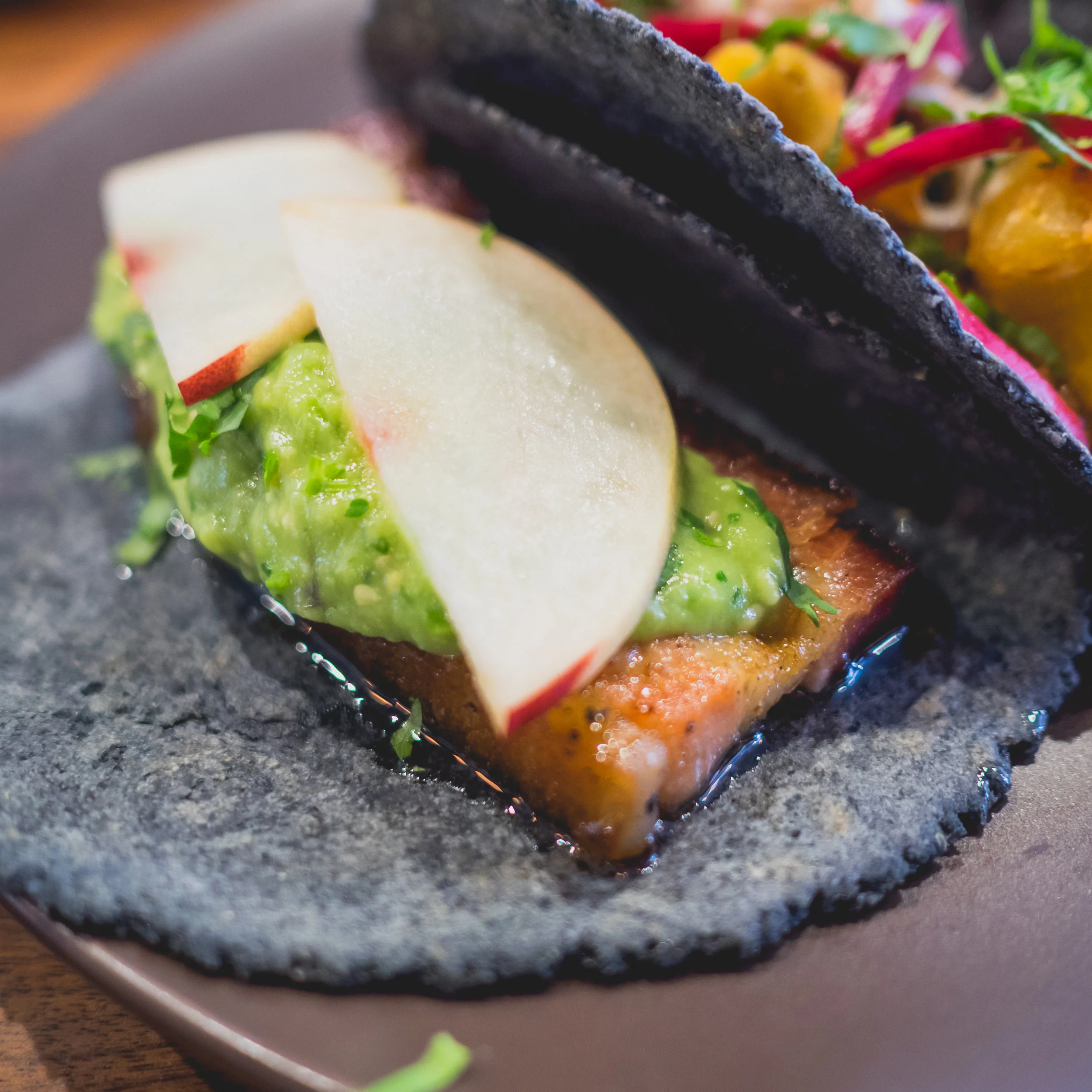 tocino : pork belly, piloncillo glaze, andy's orchard stone fruit, salsa de aguacate, cilantro.