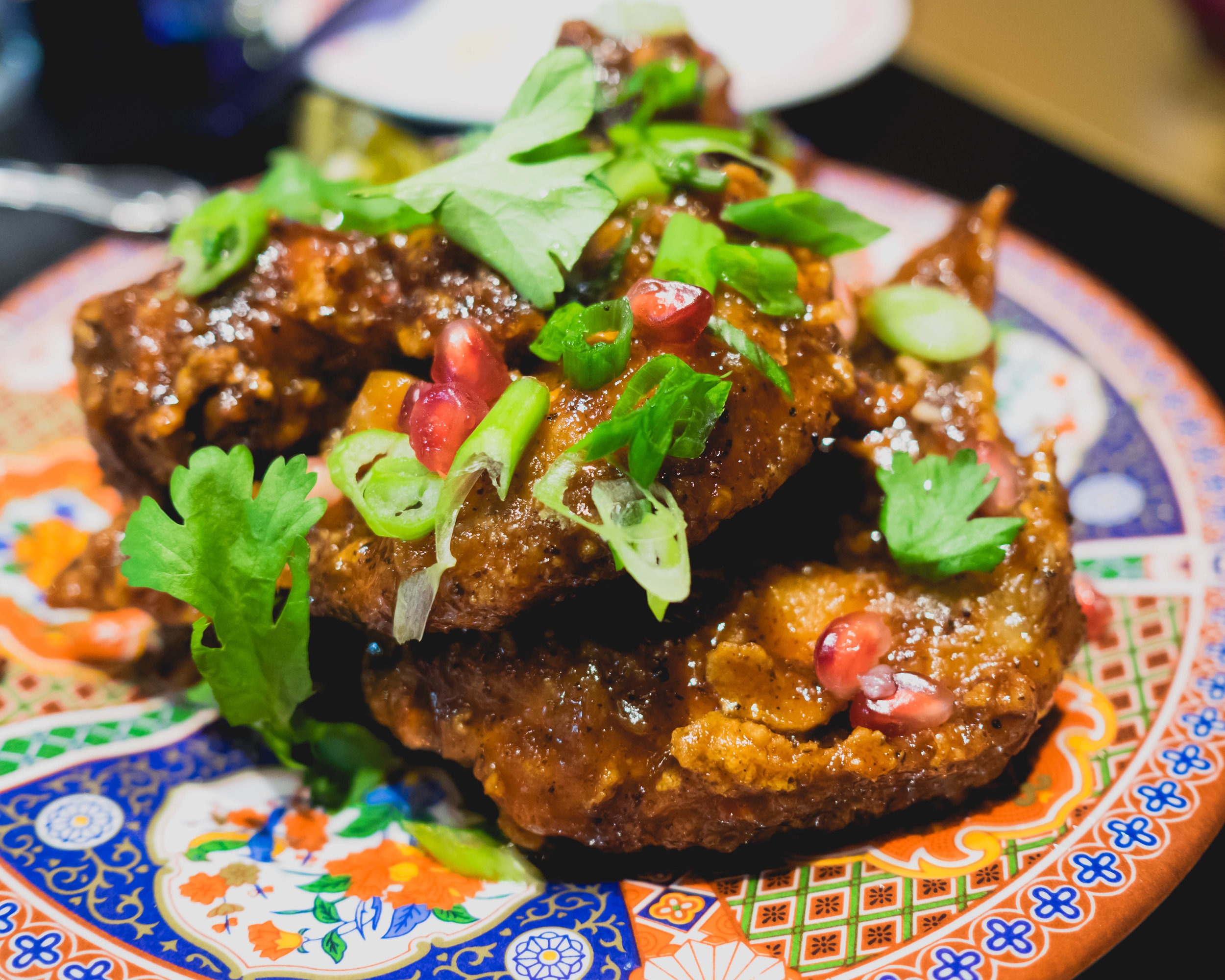double-fried tamarind chicken wings with tamarind, garlic, black pepper.