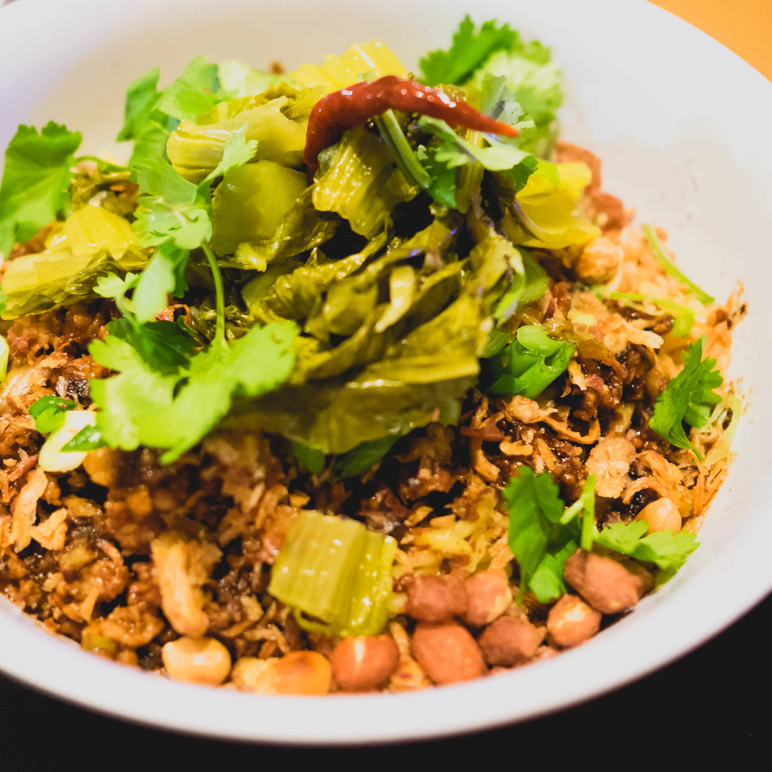 dan dan noodles with ground minced pork, peanuts, black vinegar, sesame paste, chili oil, sichuan peppercorns.