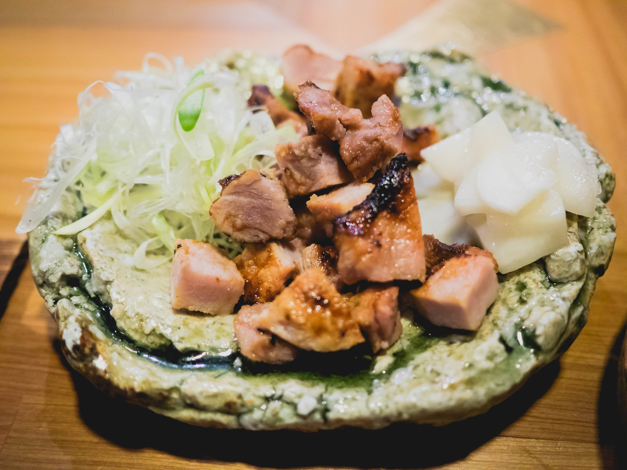 grilled heritage pork in koji, pickled daikon, leek.
