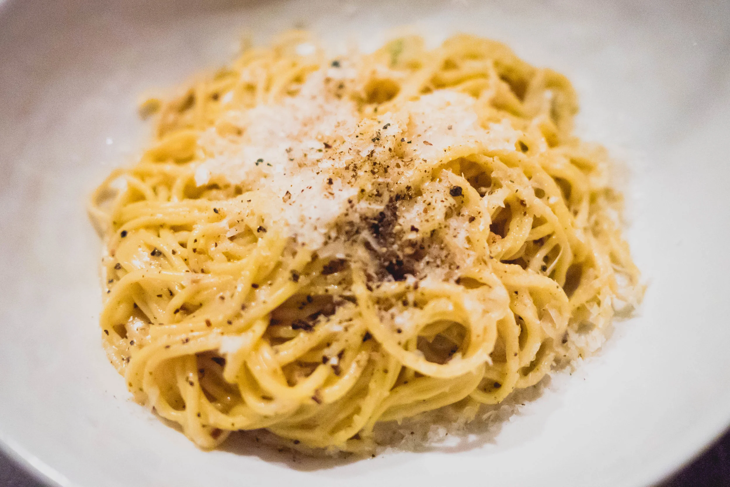 cacio e pepe with cappellini, parmesan brodo, black peppercorn.