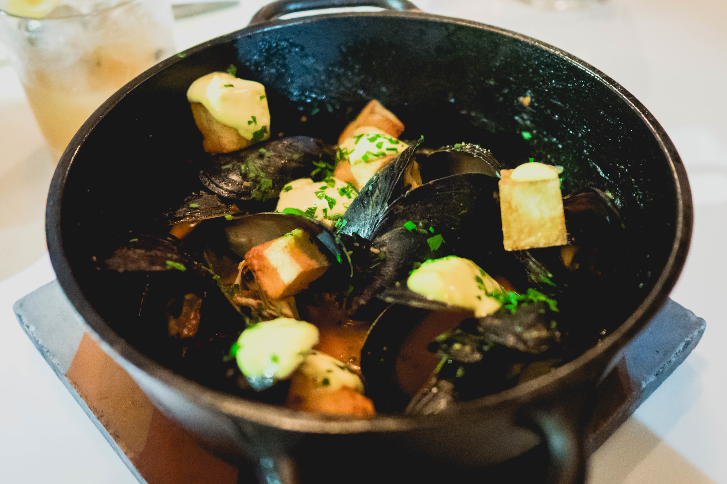 PEI mussels with "patatas bravas" , spicy tomato, saffron aioli, white wine.