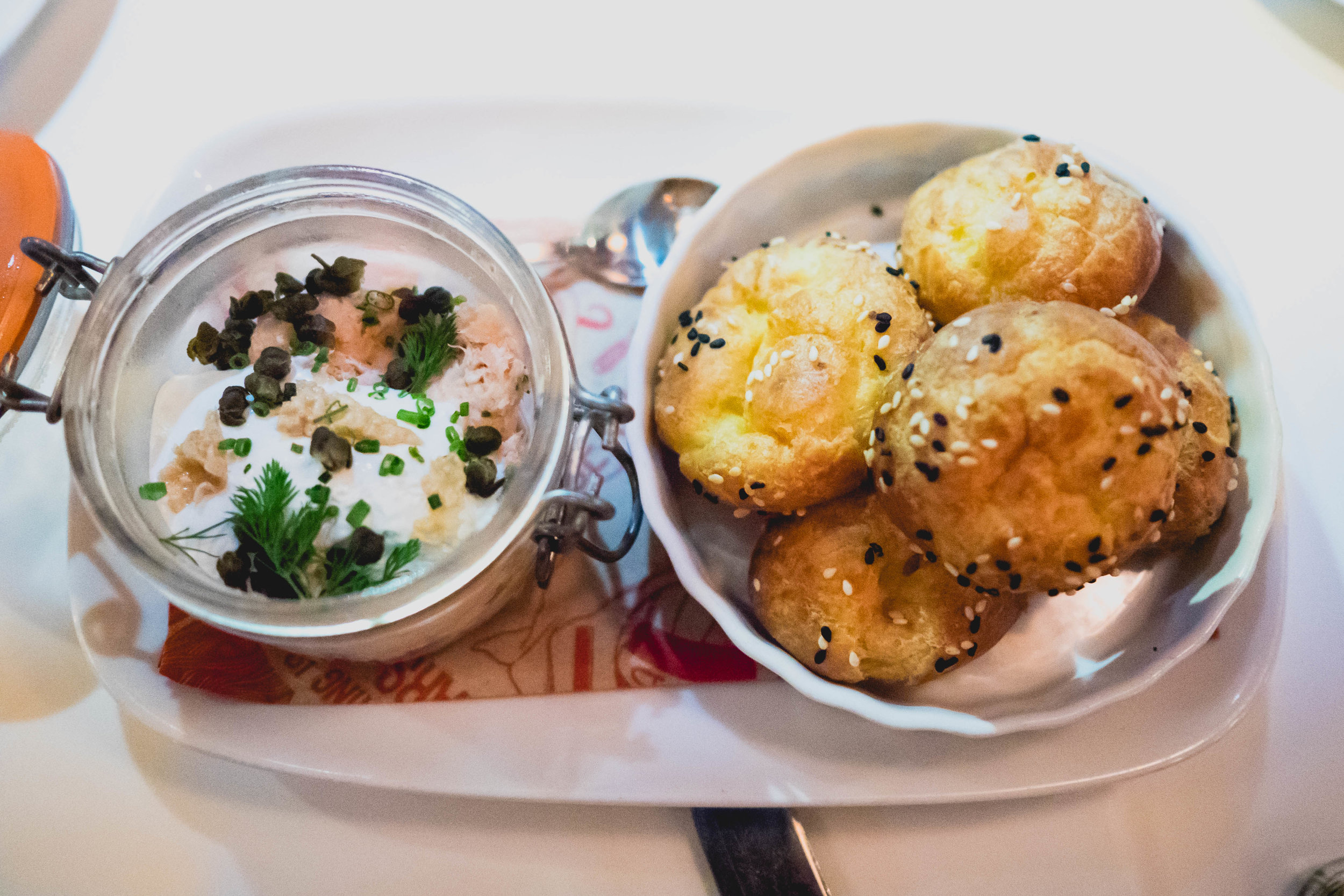 hot smoked salmon rillette with dill, capers, creme fraiche and "everything" gougeres.
