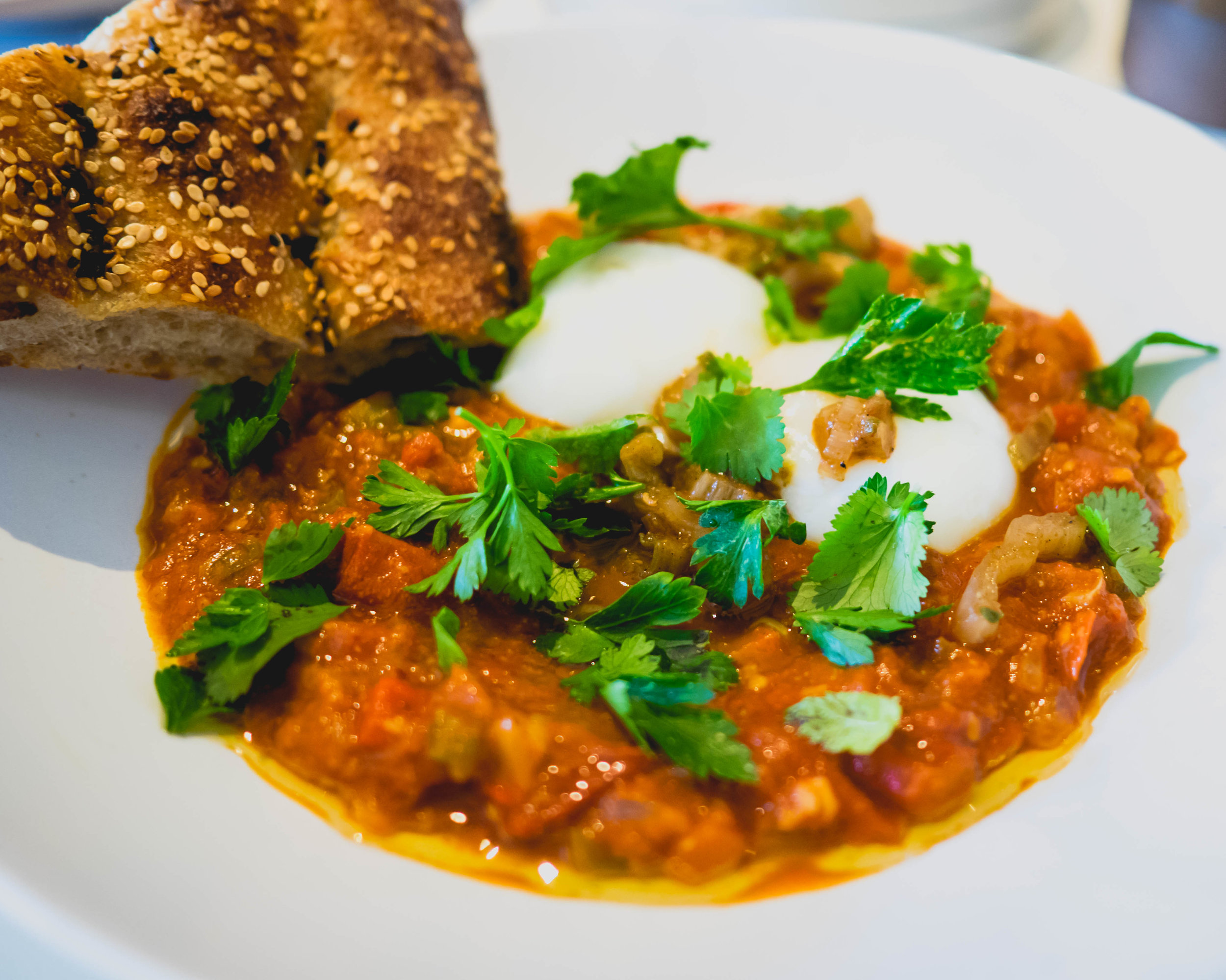 shakshuka: poached eggs in tomato stew, bread.