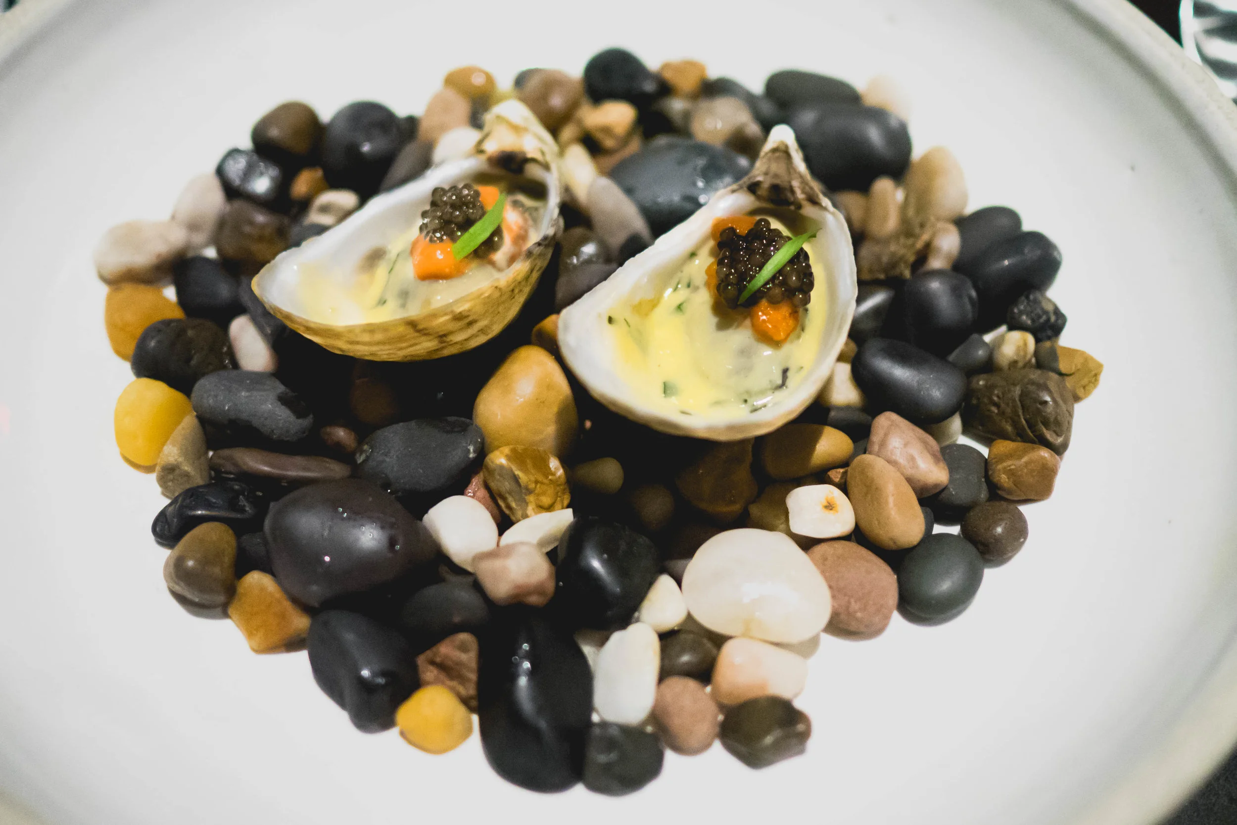 first course: poached oyster , uni, caviar, tarragon, champagne.