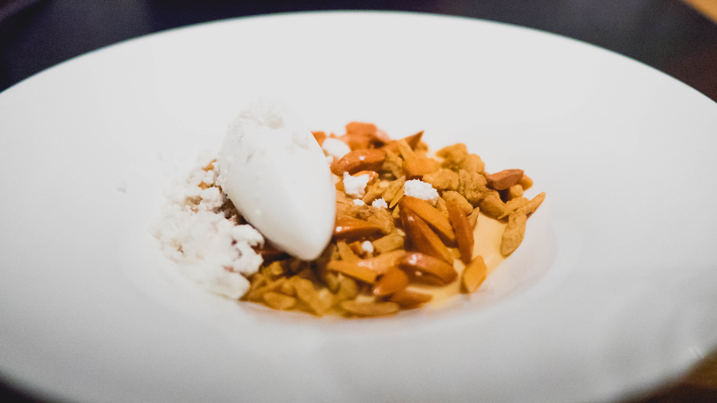 dessert: caramel custard , truffle-praline almonds, young coconut sorbet, vanilla white soy gelee, pork and maple powder.