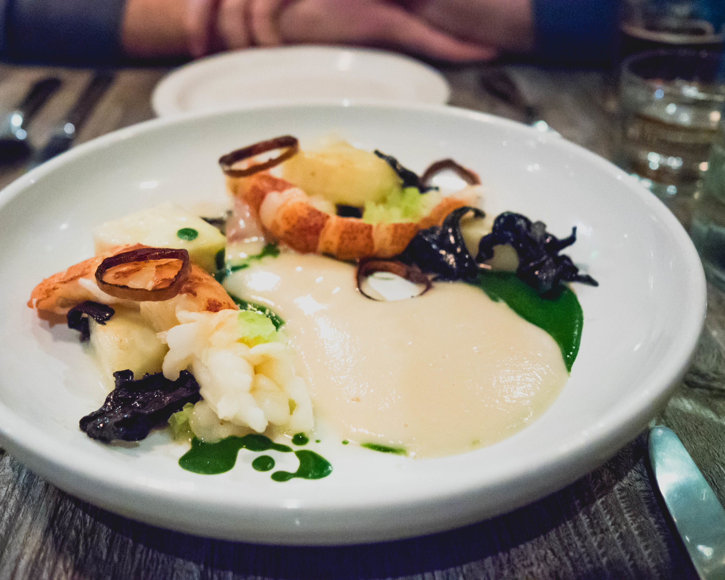 butter poached lobster , black trumpet mushroom, celery root veloute, fresno chile, parsley.