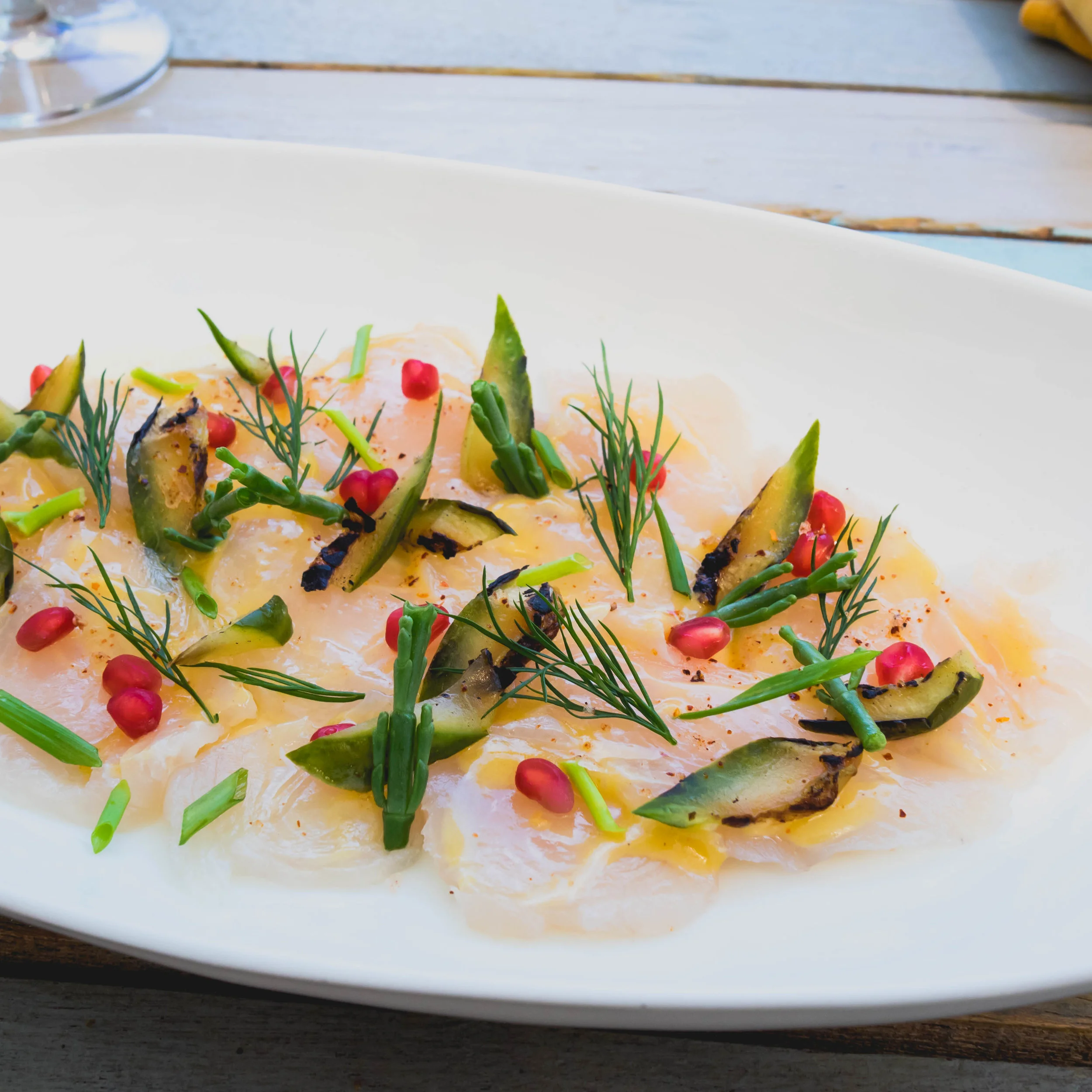 adult kingfish tiradito with samphire, burn cucumbers, pomegranate, wild lime and tequila dressing.