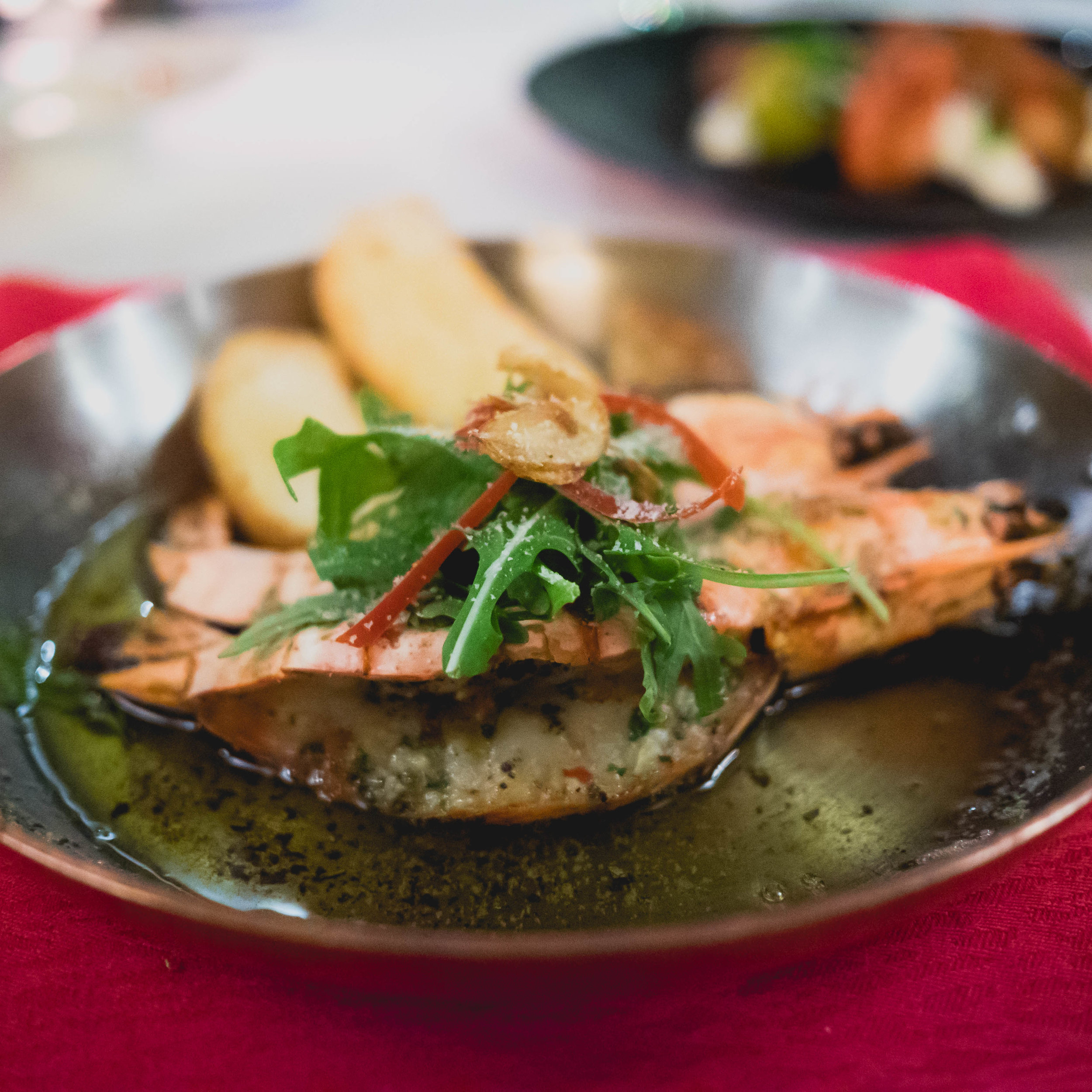 allegria's 2 king prawns from the wood fire oven with garlic and chili butter and pangritata.