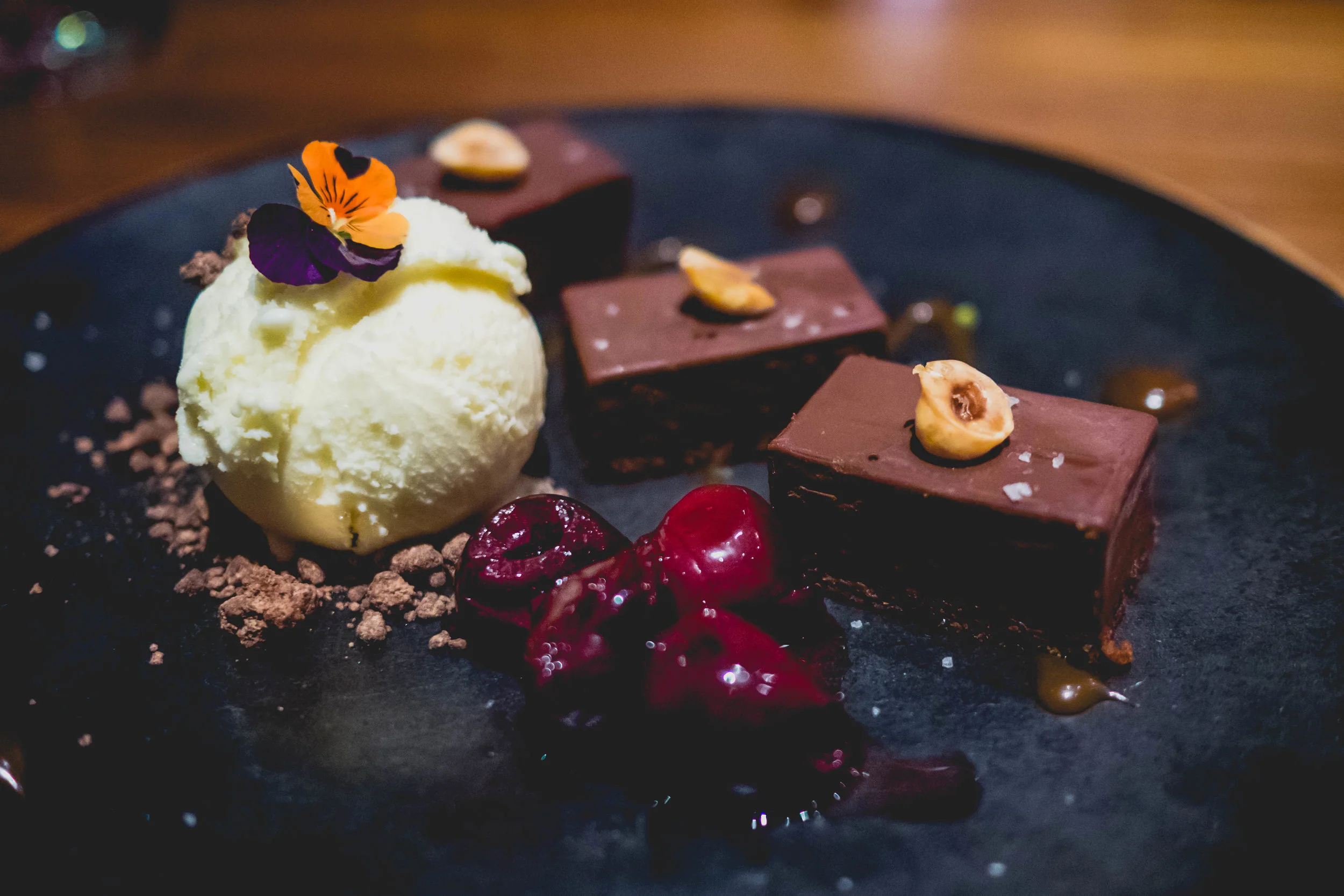 fondente al cioccolato : chocolate hazelnut crunch bar, port cherries, chocolate soil, salted caramel, white chocolate gelato.