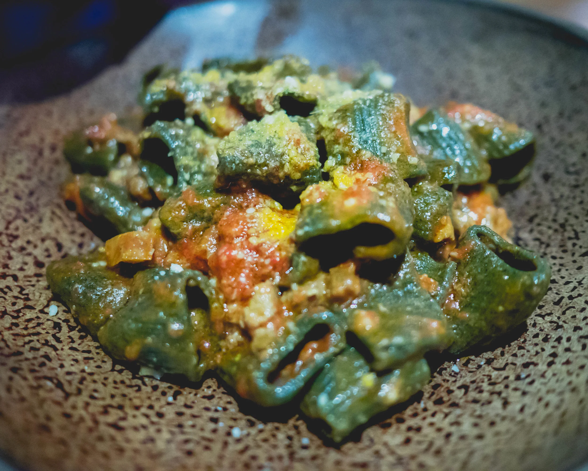 stinging nettle mezzi rigatoni , braised pork sausage ragu, parmigiano reggiano.