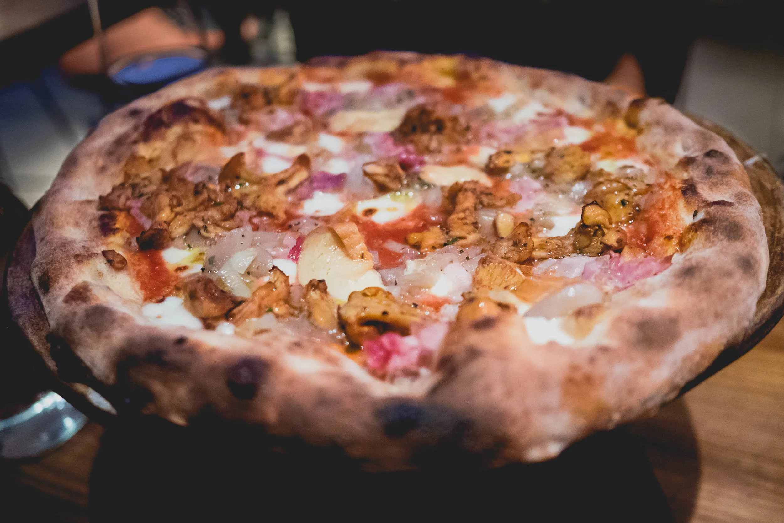 chanterelle mushrooms pizza with tomatoes, house made mozzarella, prosciutto cotto, smoked buffalo, provola, shallots.